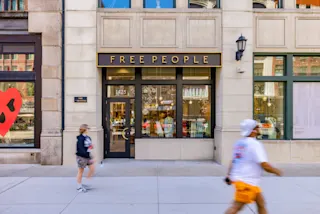 An exterior, street-level photo of the Free People storefront at The Lofts at Merchants Row.