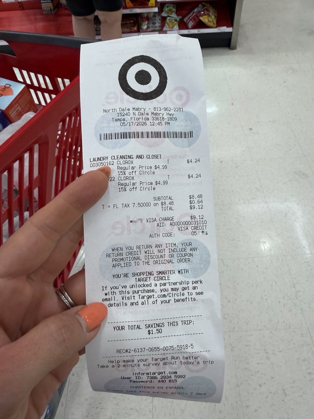 Real Target paper receipt held in front of a red Target shopping cart at a Tampa Florida store, showing two Clorox items totaling $9.12, scanned and anonymized for this article