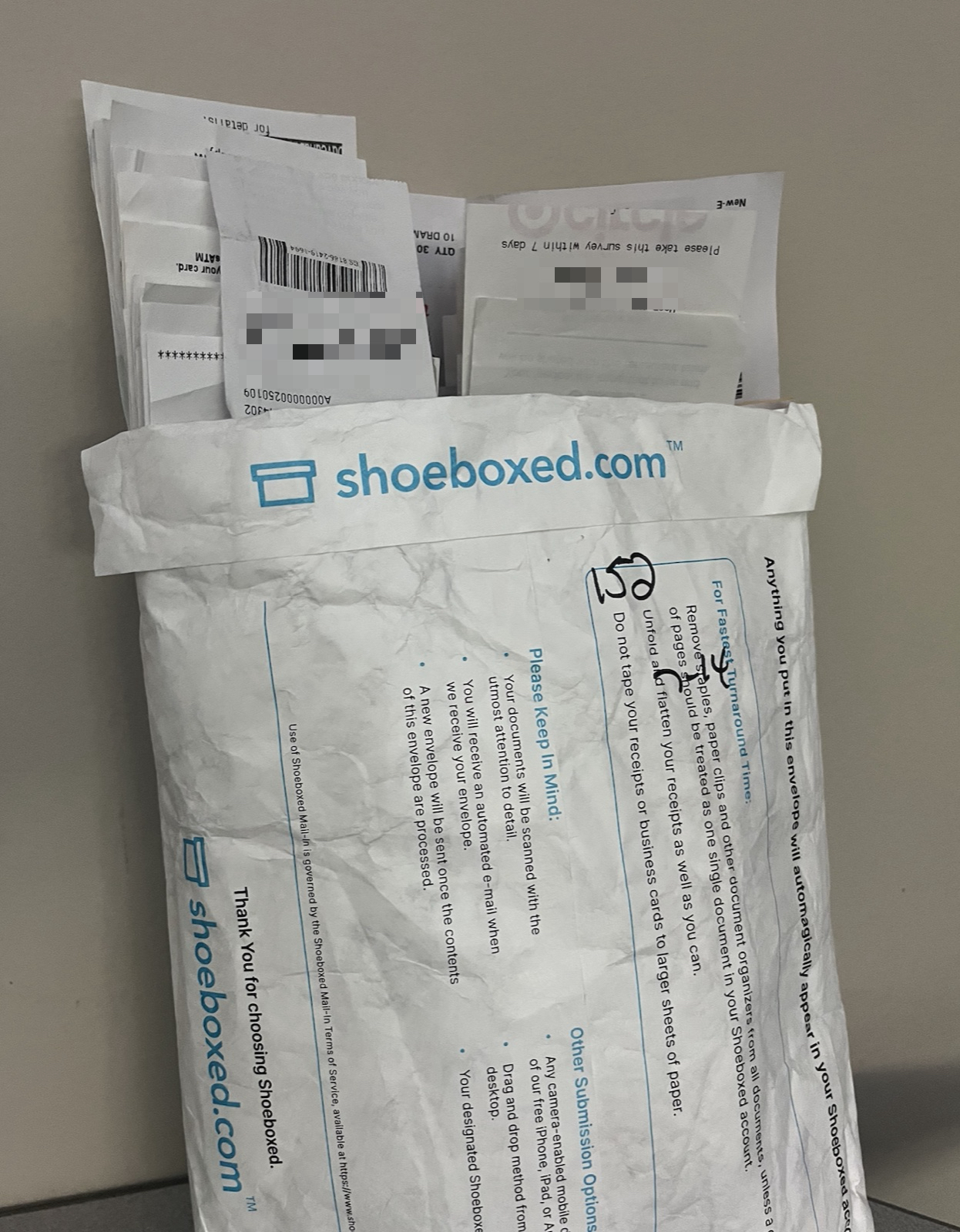 A Shoeboxed Magic Envelope full of customer receipts, with a handwritten count of 152 receipts on the front, ready to be processed in our office