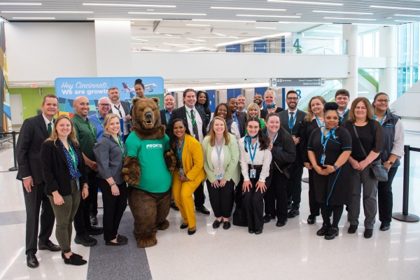 A photo of Frontier staff with the mascot for the crew base opening.