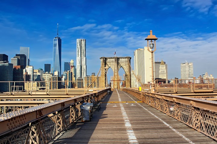 A photo of the New York City skyline when viewed from the Brooklyn Bridge.