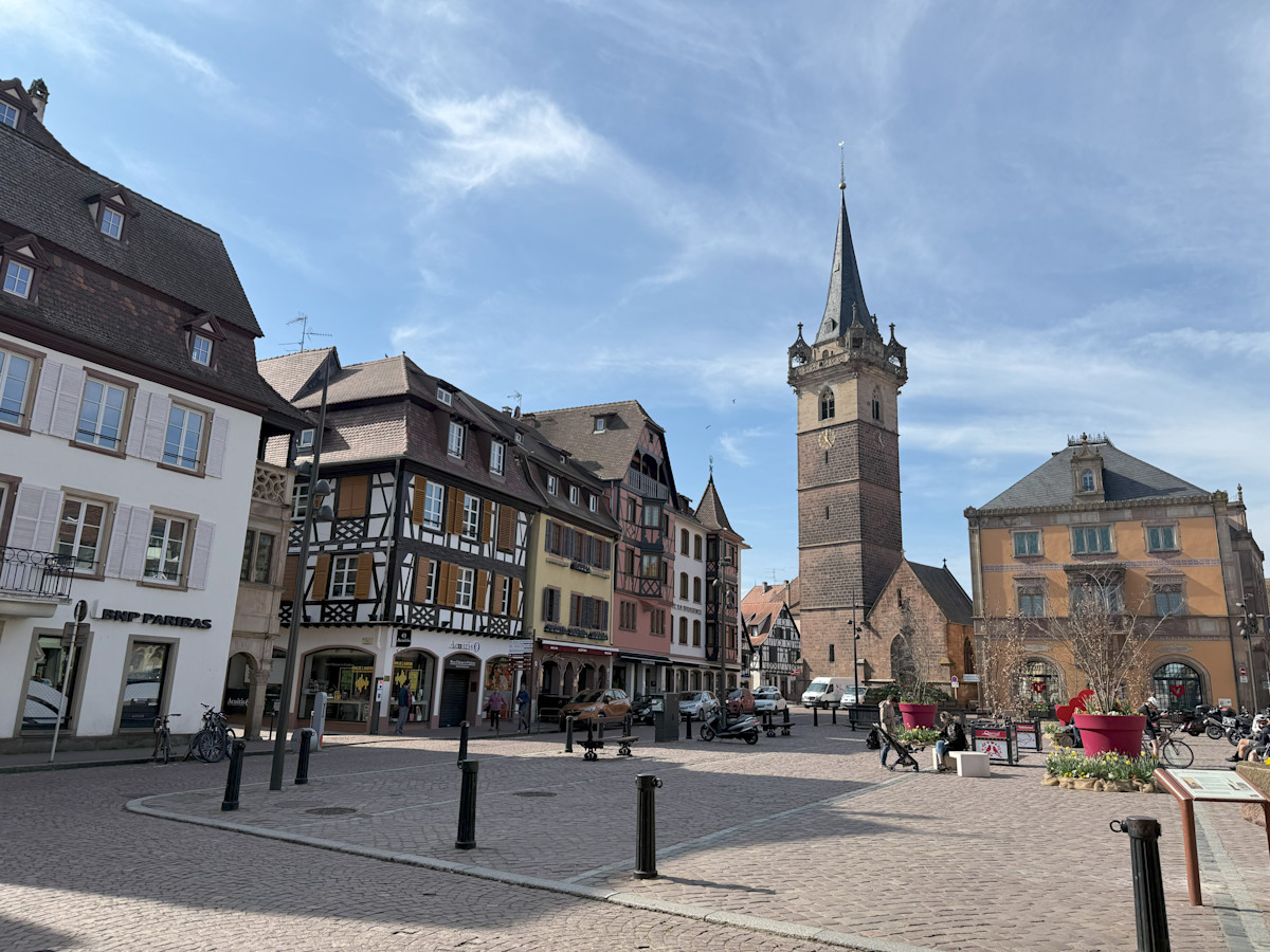 A photo of a cobblestoned square with old European style architecture all around.