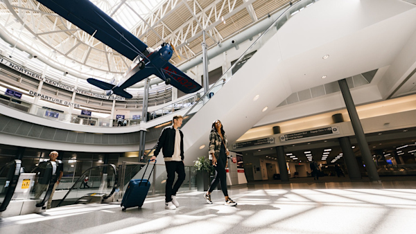 A photo of passengers just getting off the escalator in the Terminal.