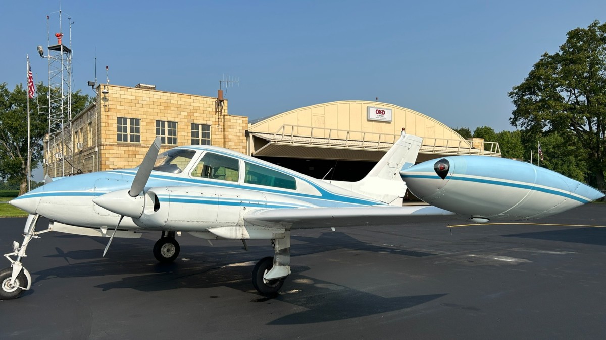 A photo of a blue and white general aviation plane outside OXD Airport.