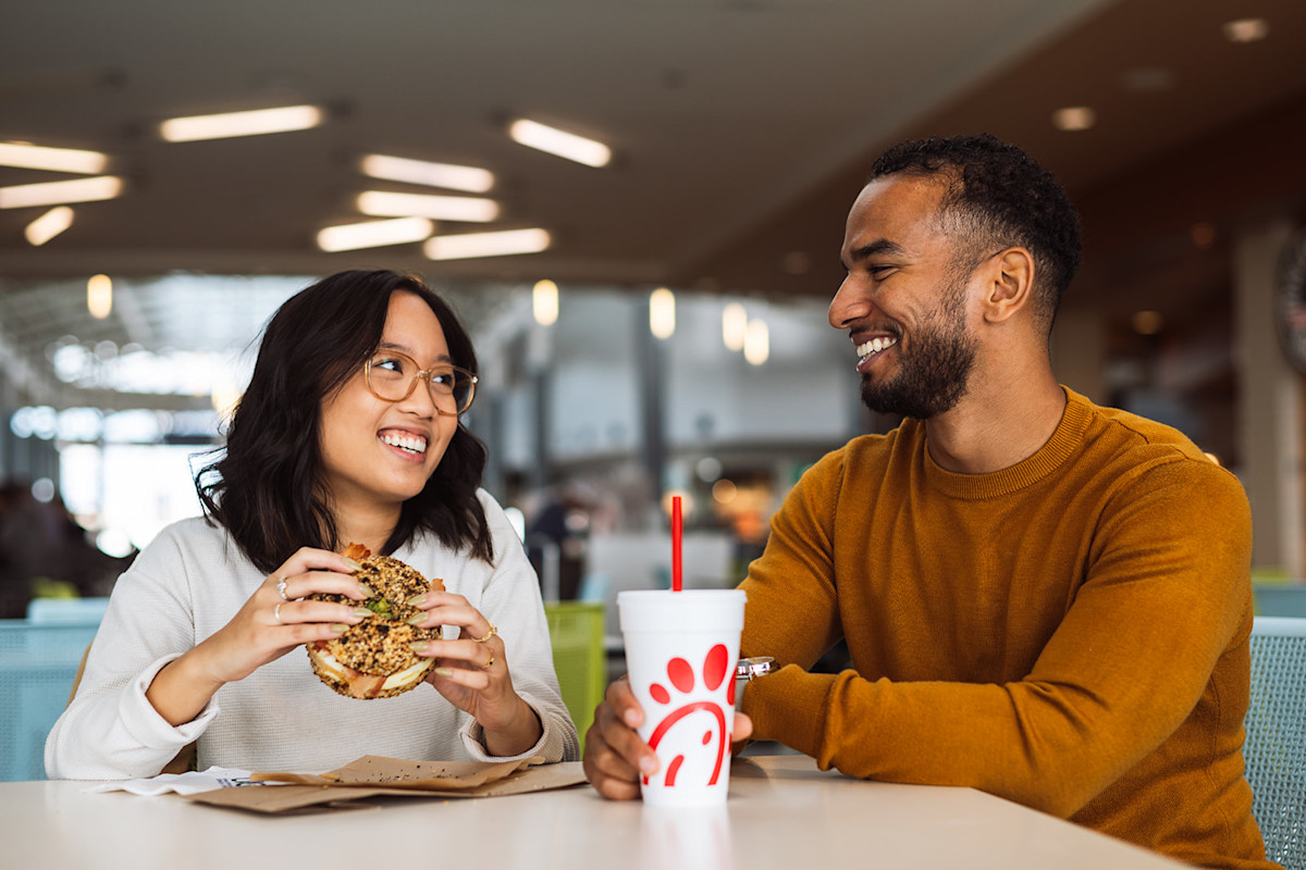 A photo of passengers dining at the Concourse B food court.