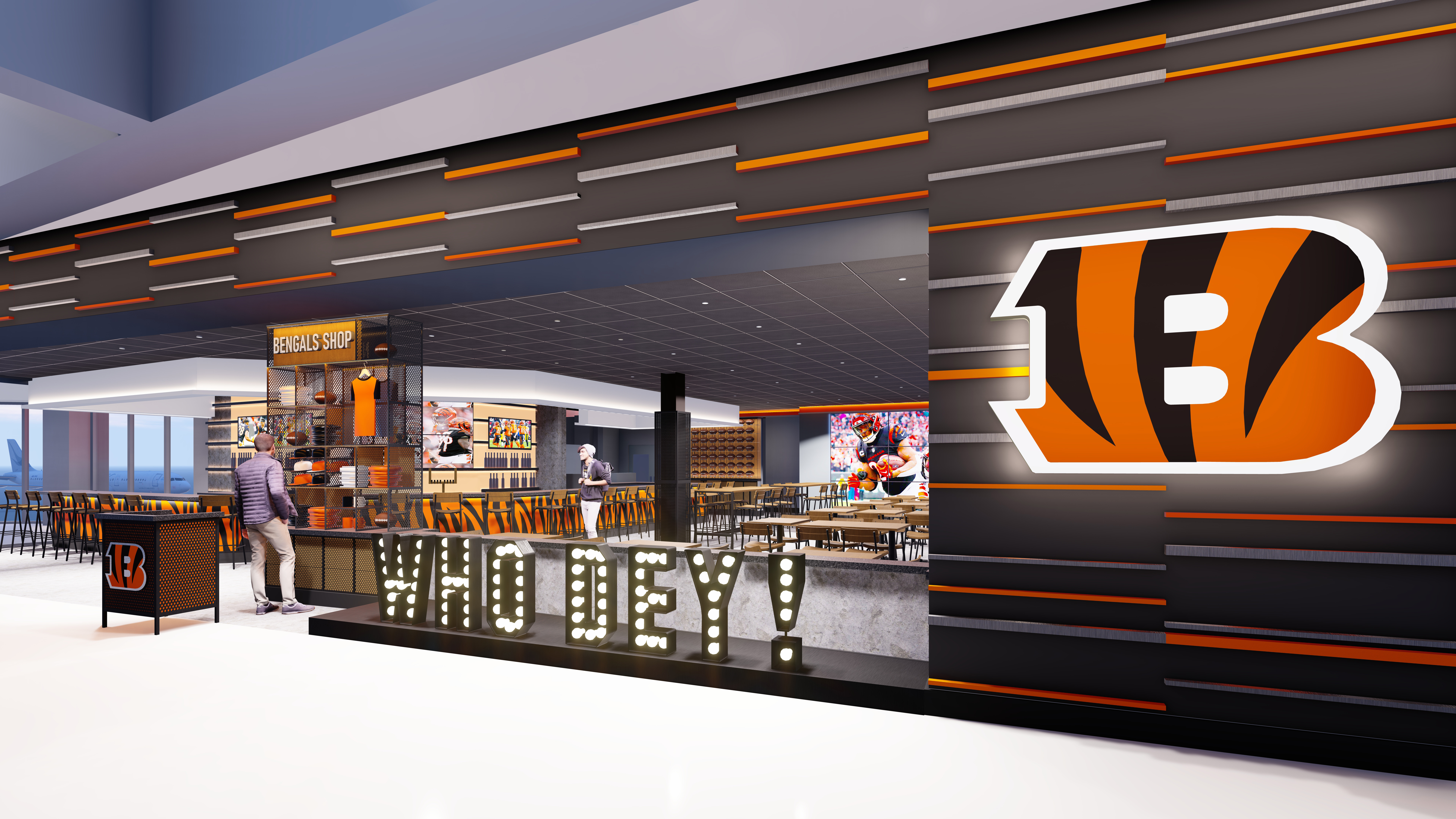 A photo of the Bengals Bar & Kitchen rendering. The walls are striped, grey, orange, and black. There is a light up Who Dey sign in front and a Bengals B on the front wall.