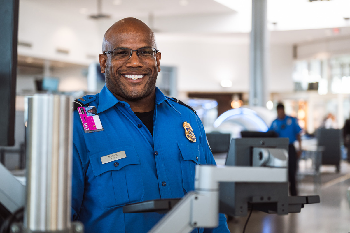 TSA Officer Smiling at Checkpoint
