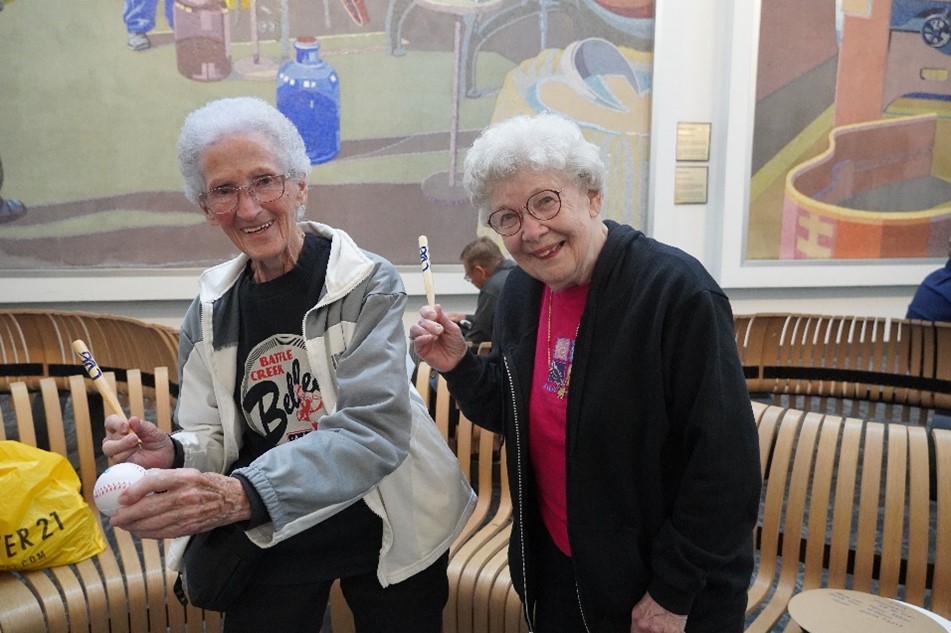A League of their Own - Mary Moore and Lois Youngen with Baseballs in Baggage Claim