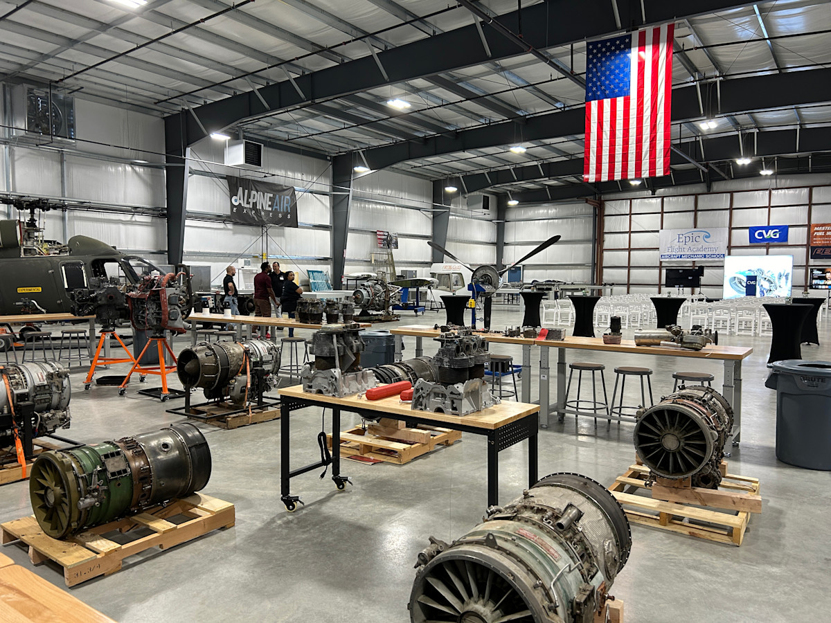 A photo of inside Epic Flight Academy with plane parts on display throughout the hangar-like space.