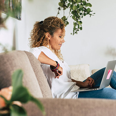 woman-on-couch-looking-at-laptop-header-mobile