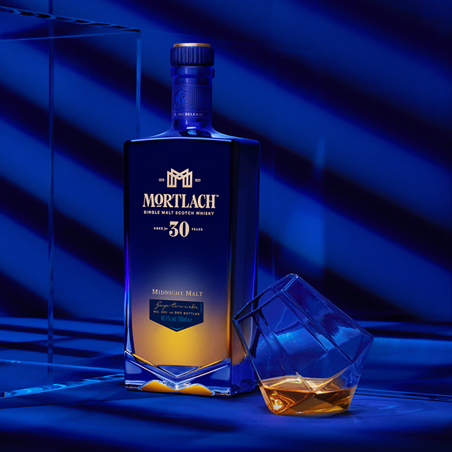 Mortlach 30 Year Old on a table with a glass of whisky on a blue room