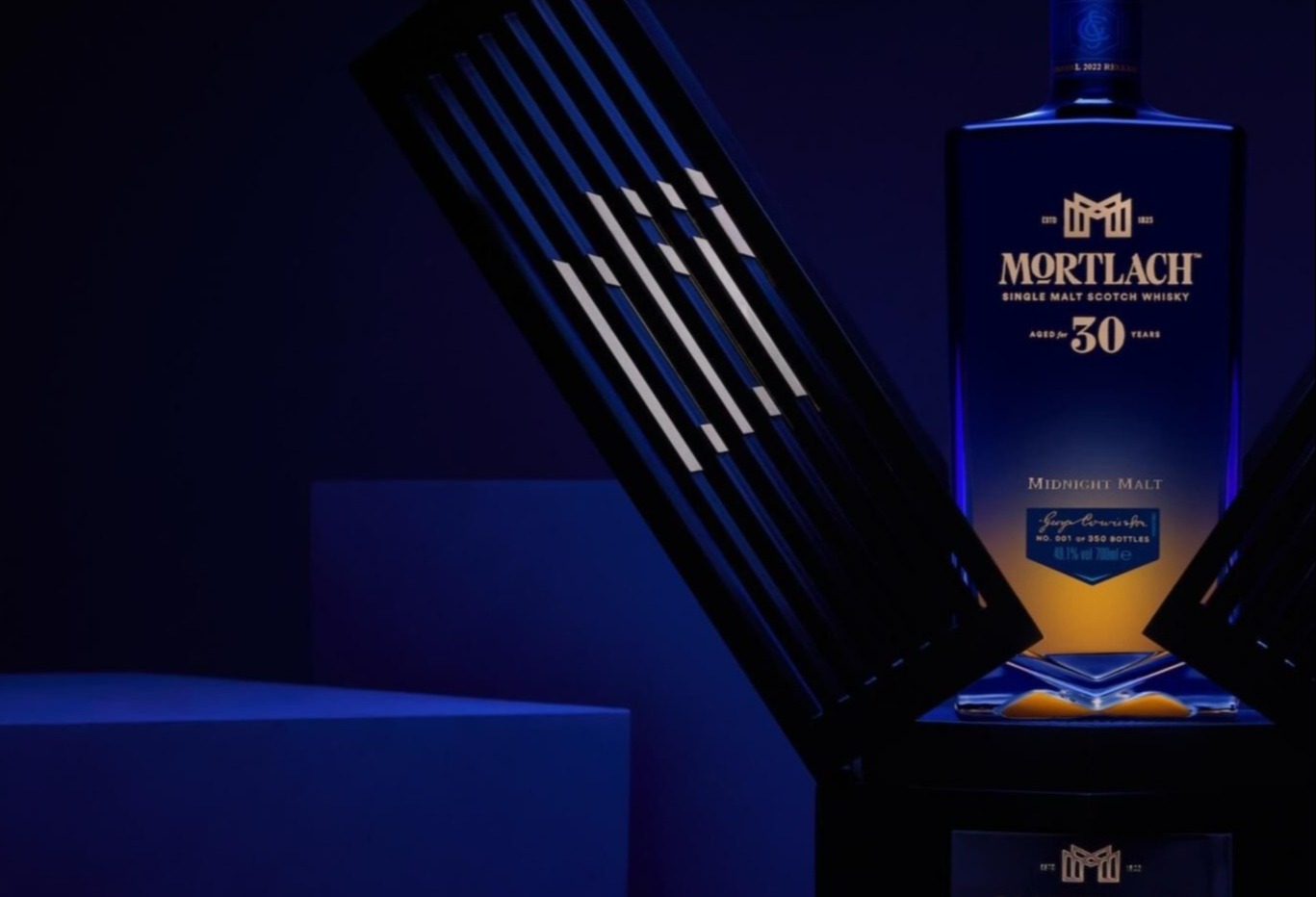 A dark, luxurious setting featuring a bottle of Mortlach 30-Year-Old Single Malt Scotch Whisky