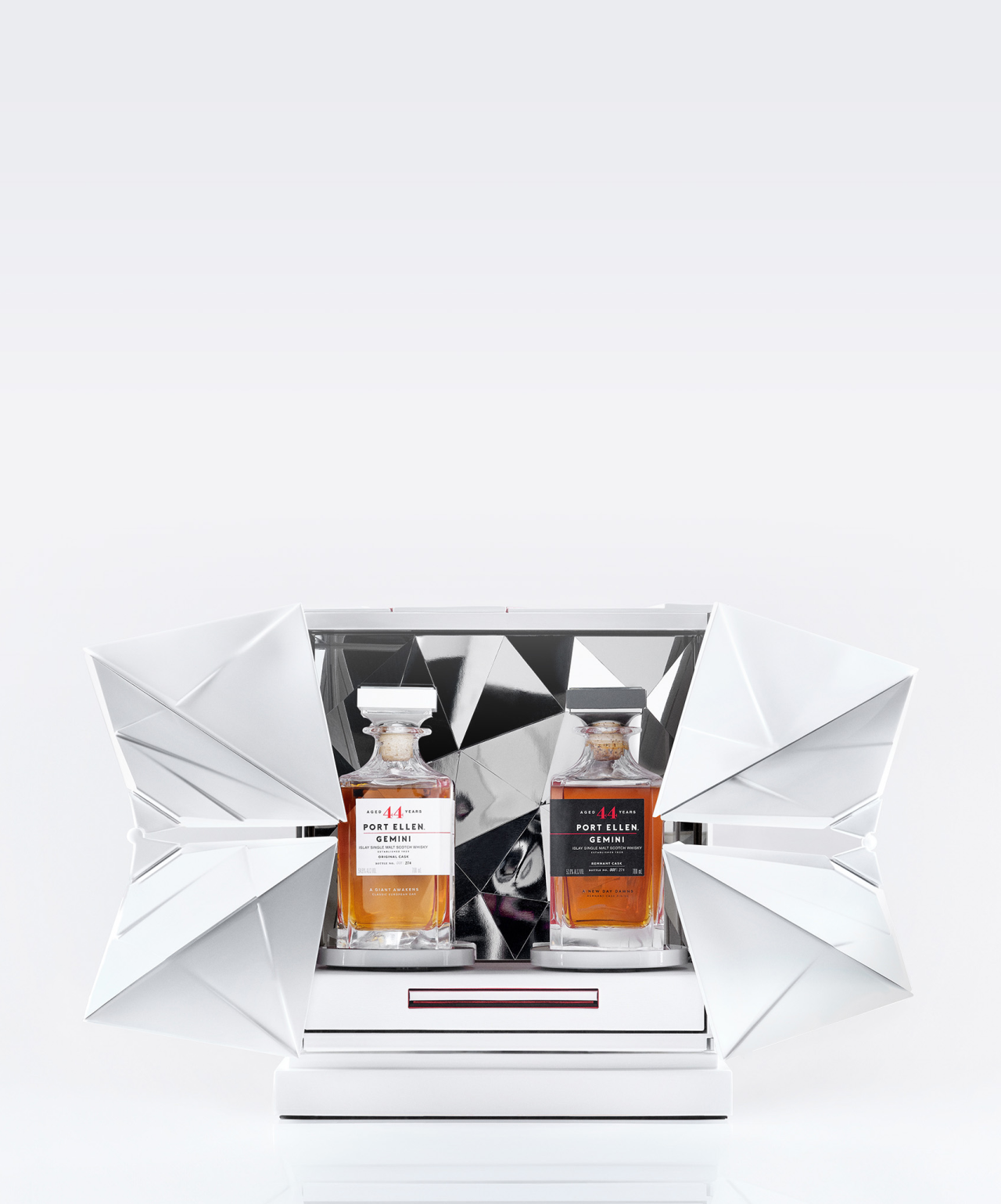 A luxurious display of two Port Ellen 44-Year-Old whiskies, one with a white cap and one with black