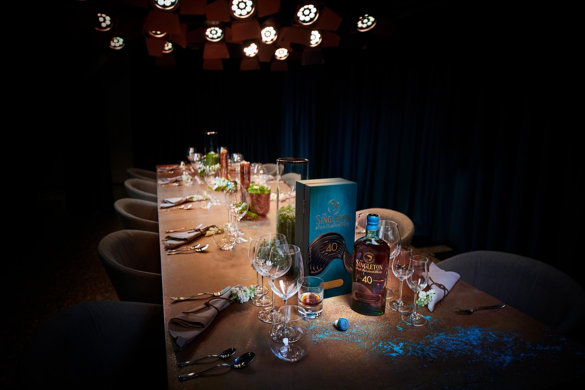 A beautifully set dining table featuring a bottle of The Singleton 40-Year-Old Single Malt Scotch Whisky