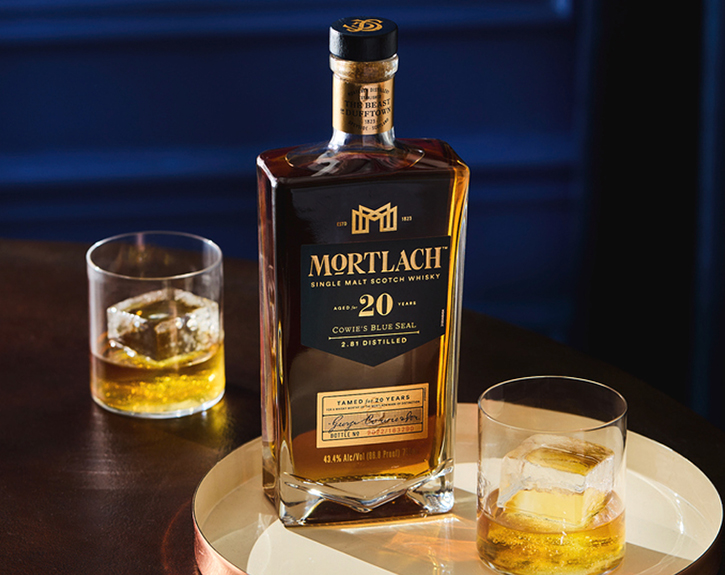 Mortlach 20 Year Old on a table with two glasses of whisky one in front and one at the back of the bottle