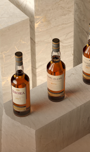The image features three bottles of whisky displayed on marble pedestals.