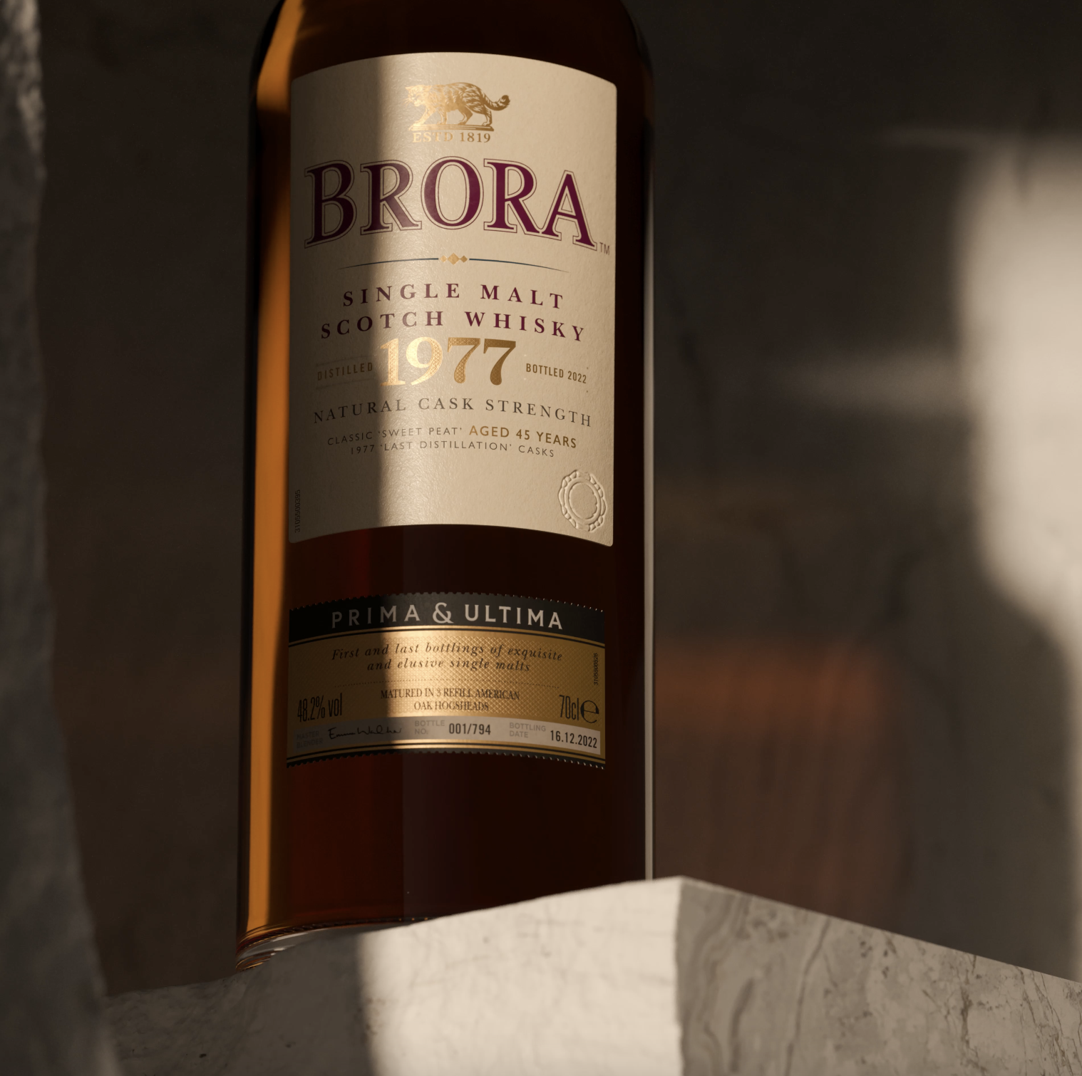 "A bottom-to-top shot of a Brora (1977) whisky bottle, standing on a marble surface. 