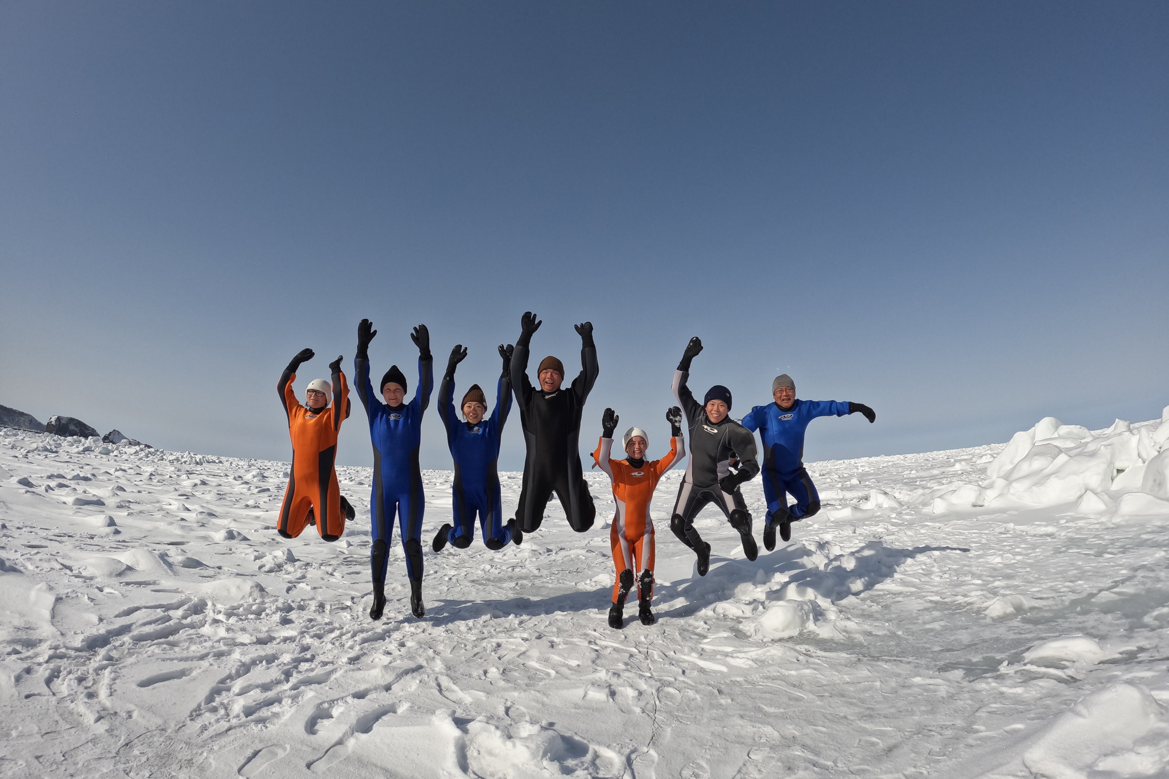 Guests jump for joy on drift ice at Shiretoko Peninsula.