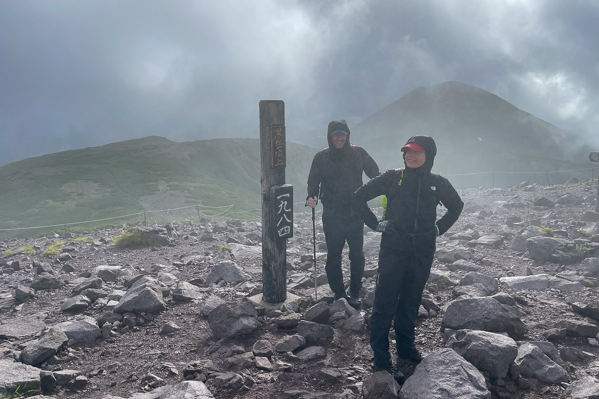 Two hikers on the summit of Mt. Kurodake