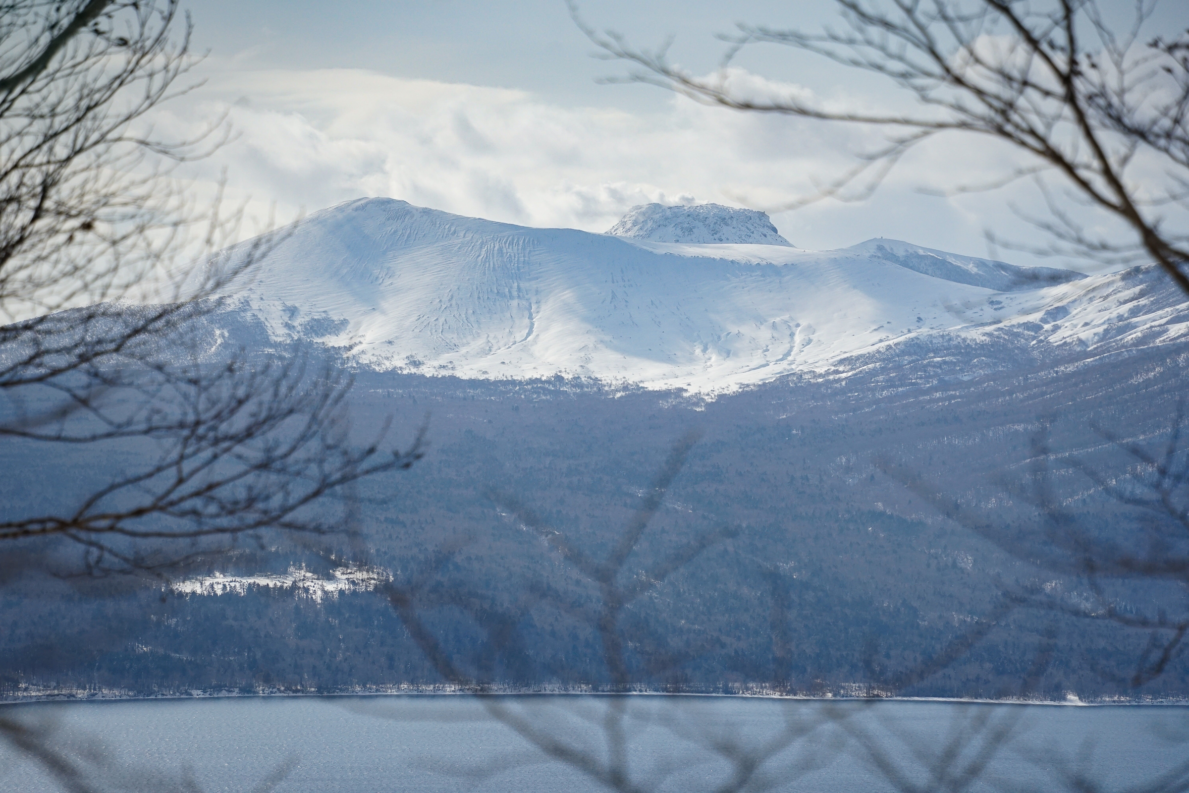 Snowcapped Mt. Tarumae viewed across Lake Shikotsu.