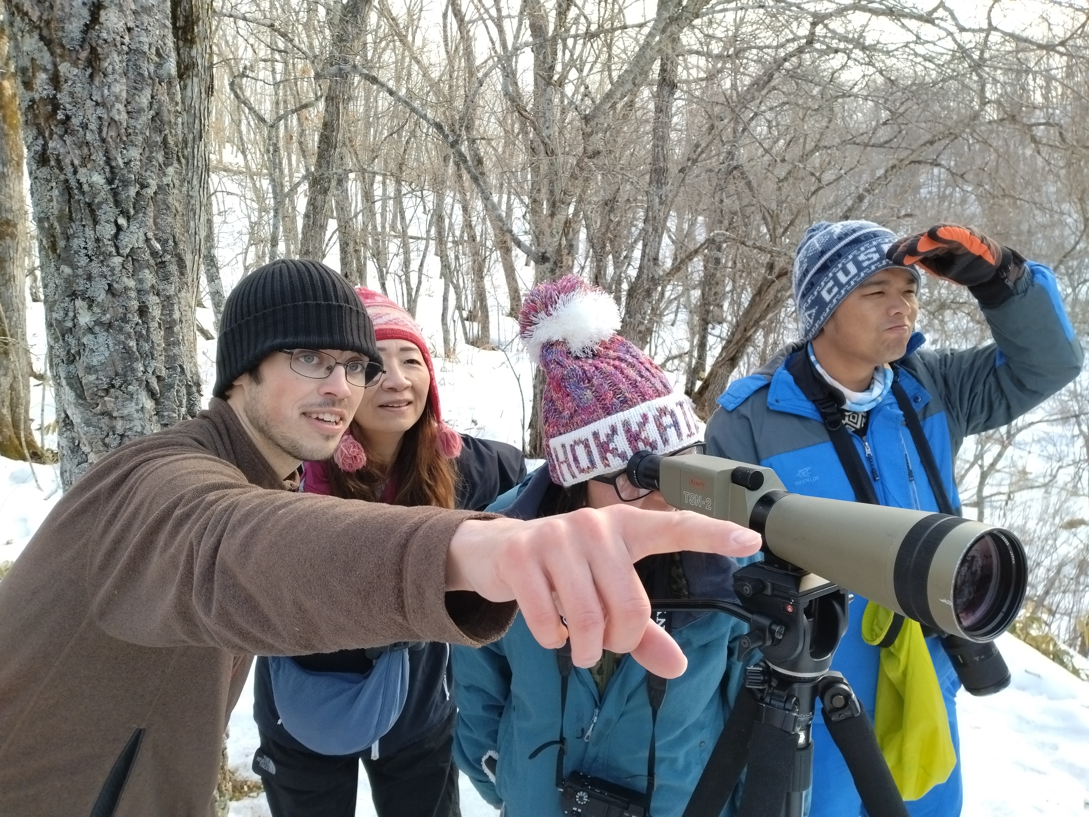 Adventure Hokkaido guide Zac explains natural features to guests looking through a telescopic lens.