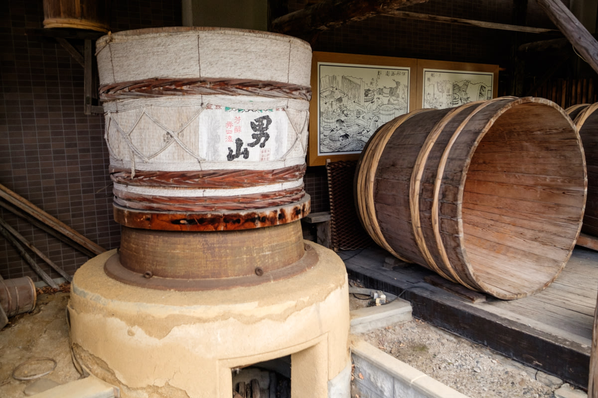 An old Sake barrel on display at a distillery