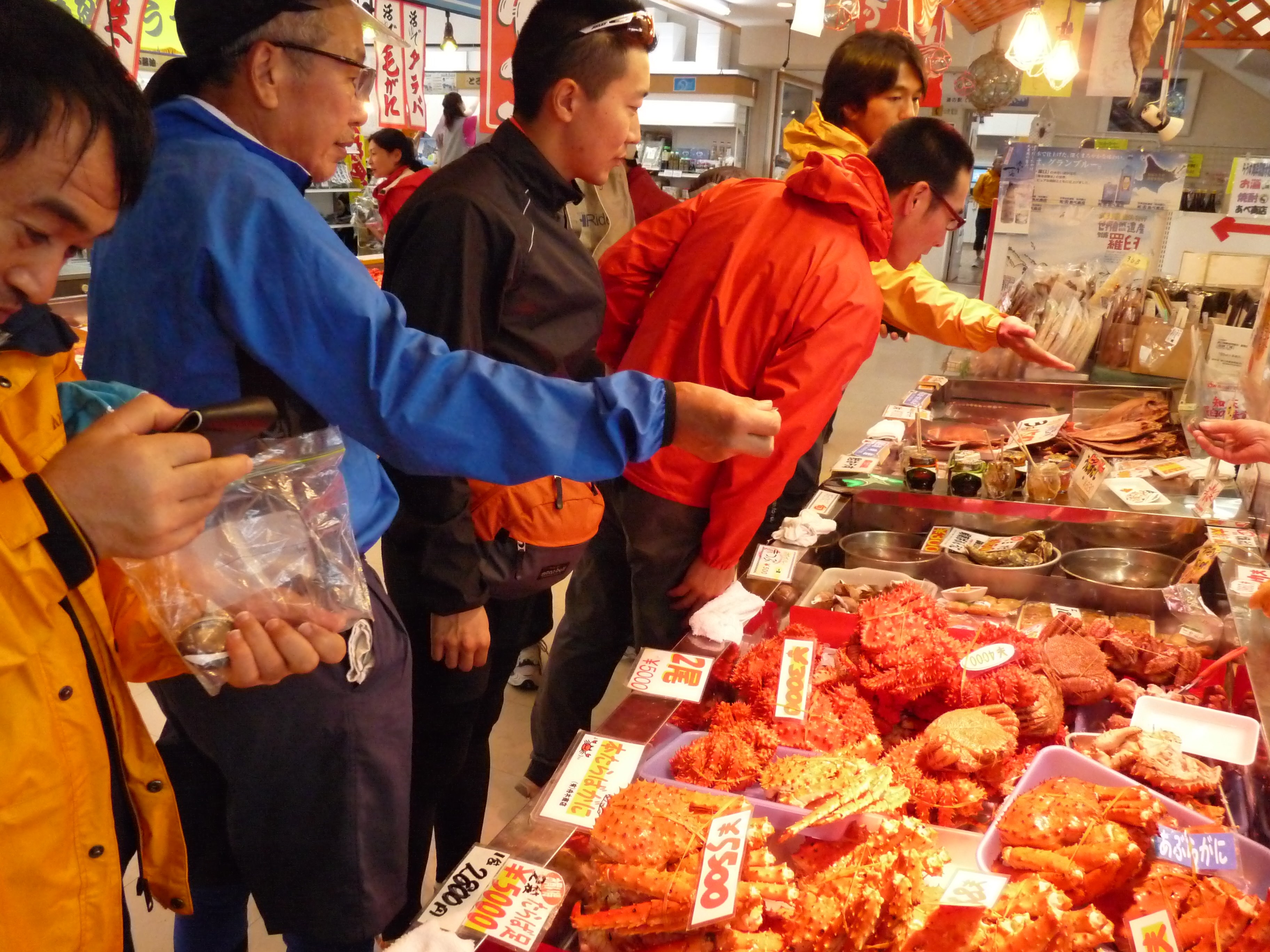 Patrons observe offerings at a seafood market in Rausu.