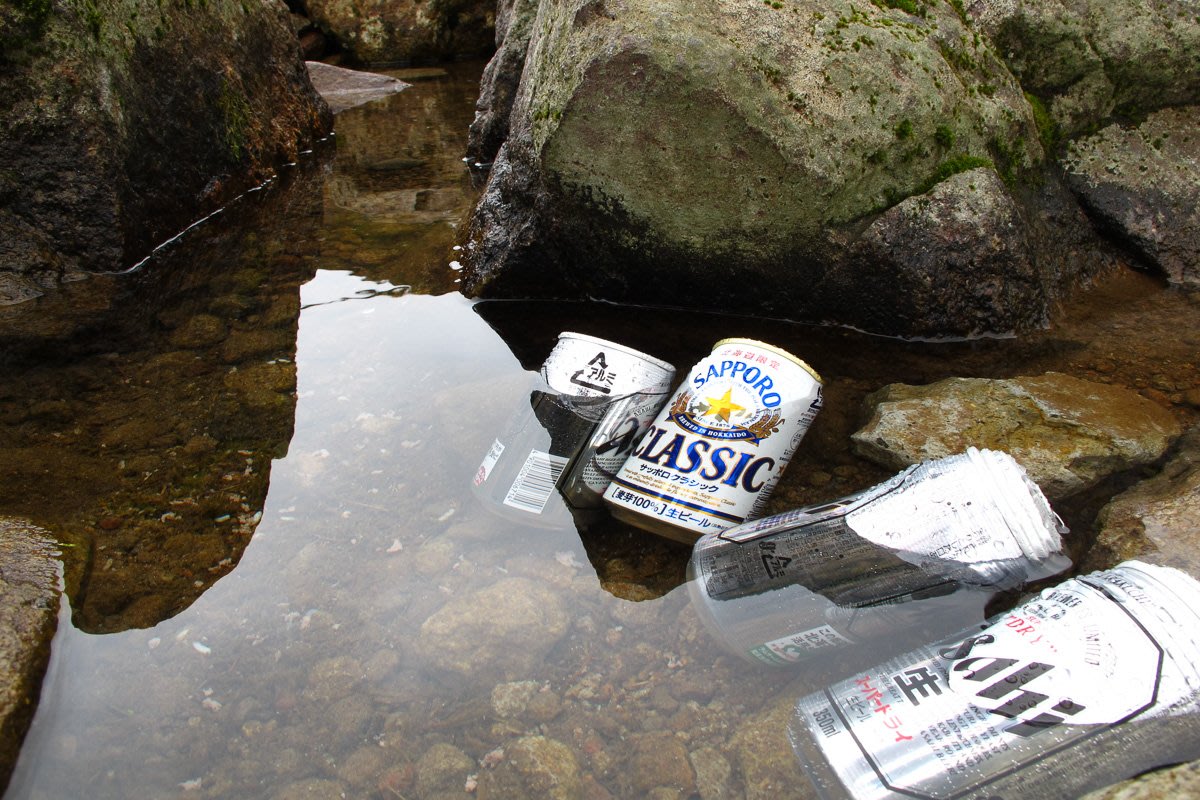 Beer cans keeping cold in a Hokkaido mountain stream