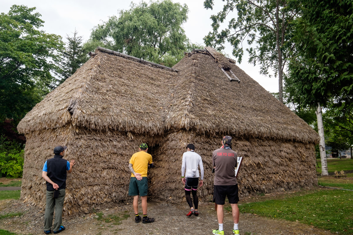 A group look at the walls of a traditional Ainu house, or Cise