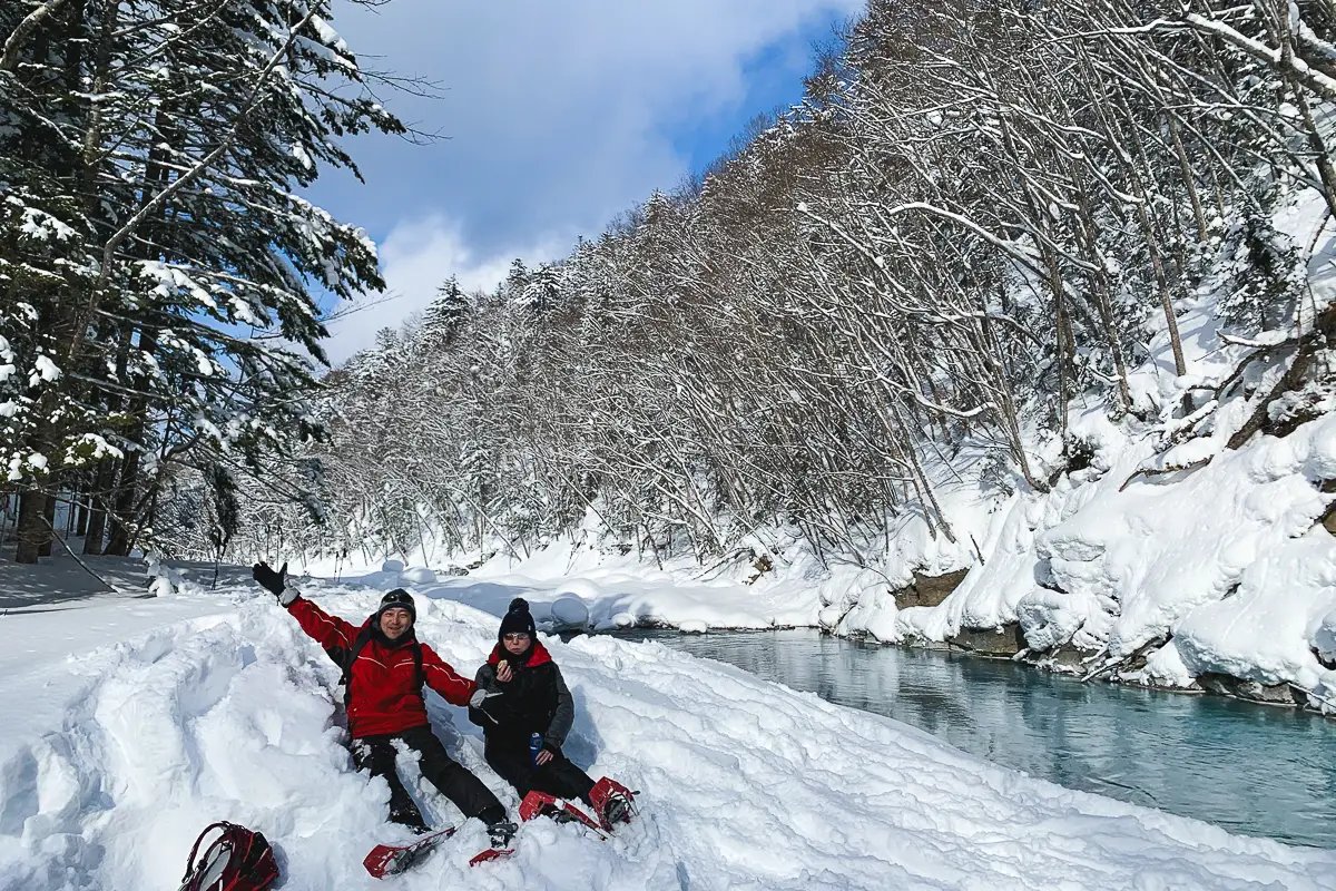 Snowshoers resting by the Biei Blue River in Hokkaido