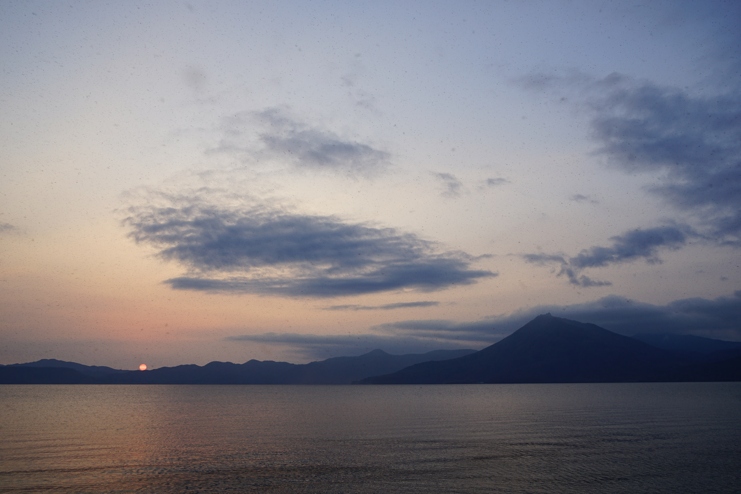A romantic shot of the sun setting at Lake Shikotsu.