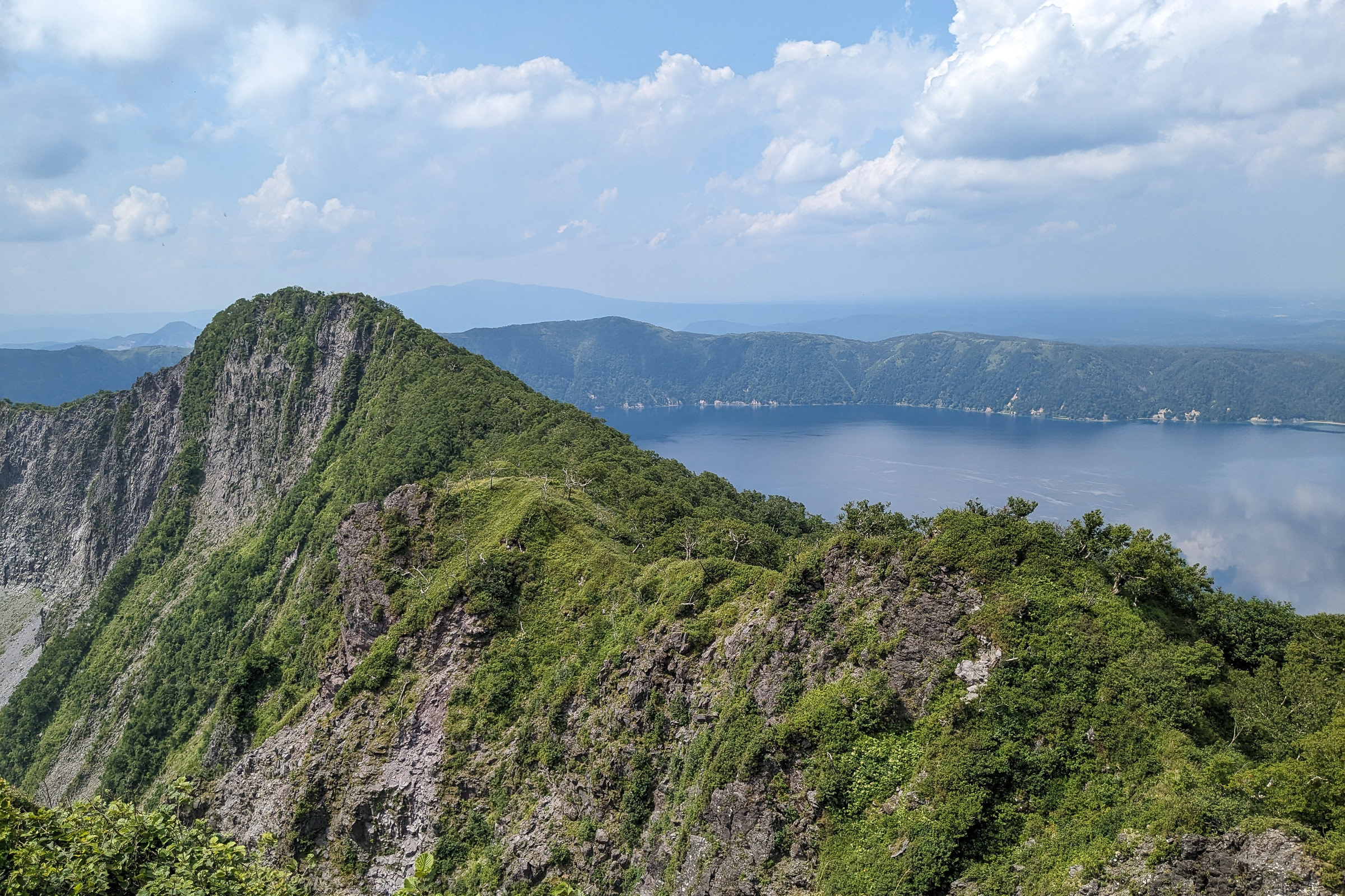 Lake Mashu, a caldera surrounded by steep cliffs and mountains.