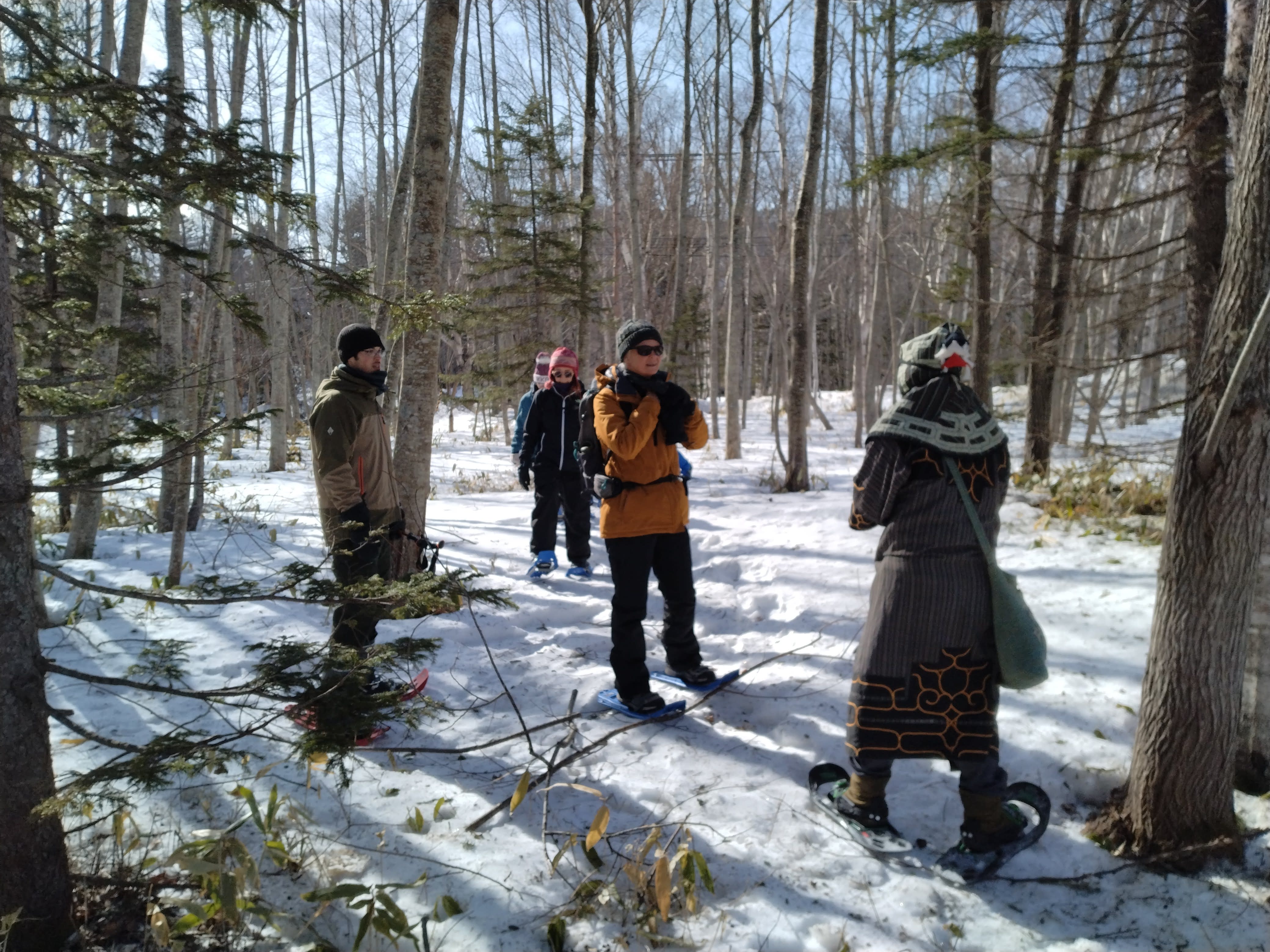 Guests snowshoe while learning about Ainu history and culture.