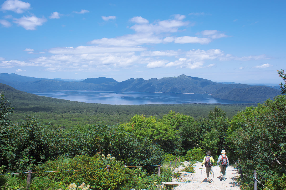 Hikers enjoying views of Lake Shikotsu on the Tarumaezan hiking trail in Hokkaido