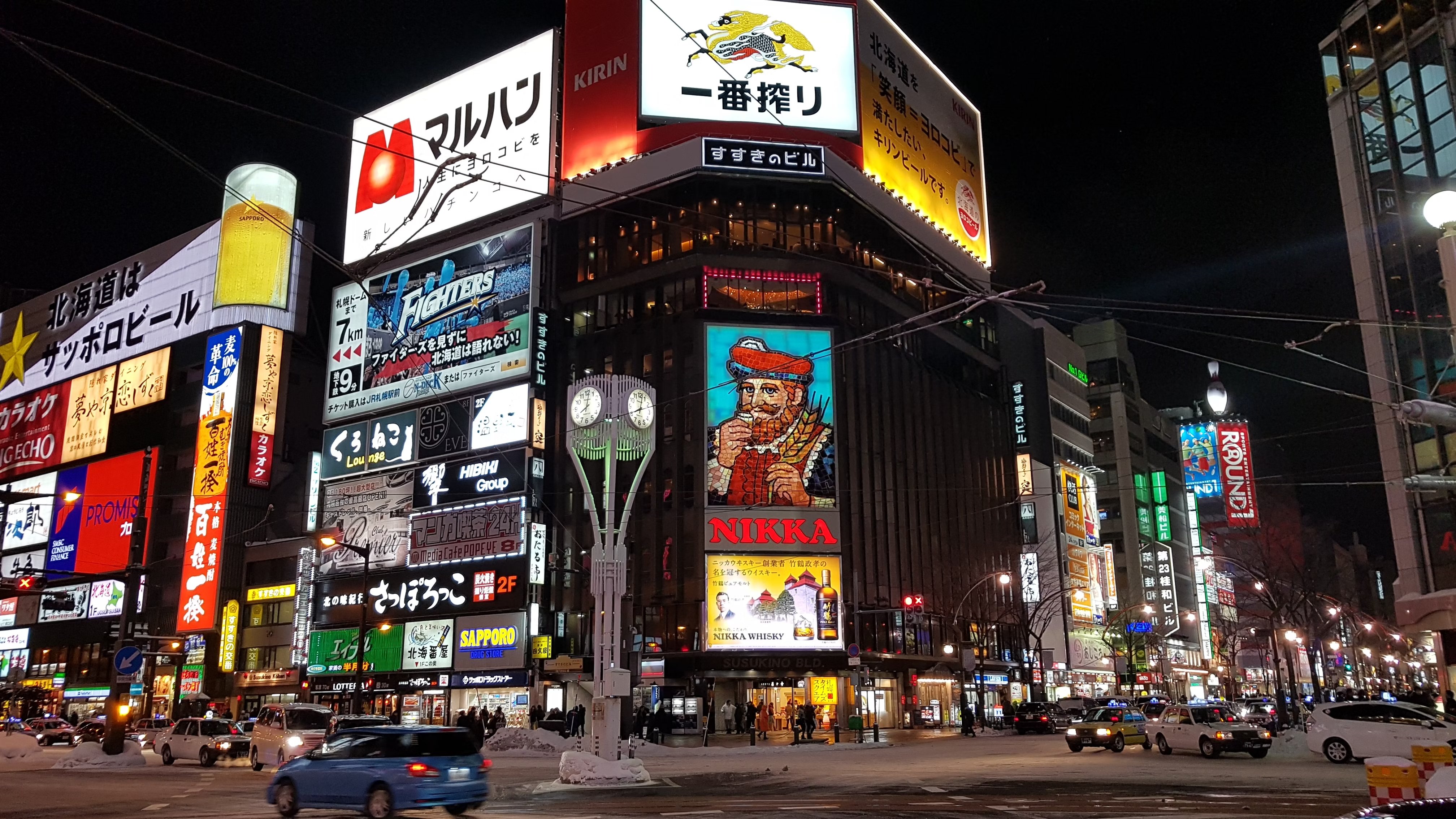 Advertising banners light up an intersection in Susukino, Sapporo's night life district.