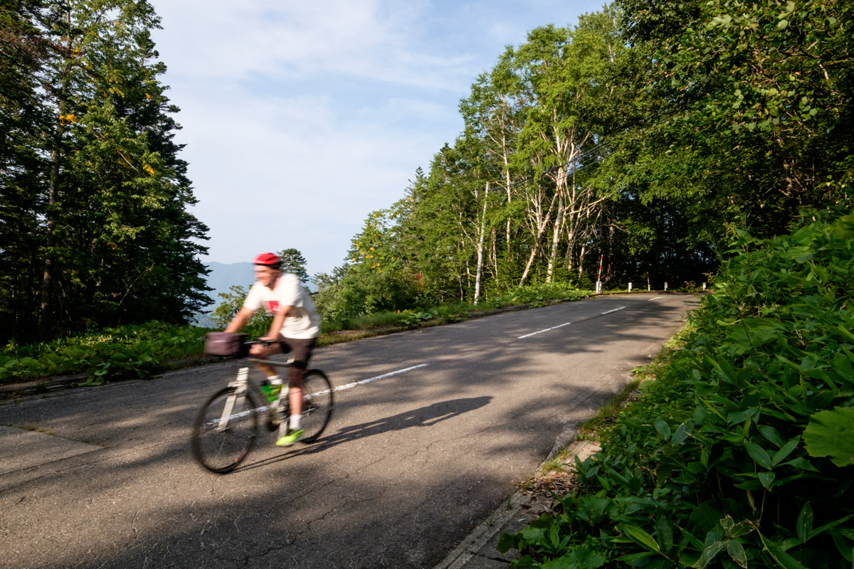 A cyclist speeds down a hill