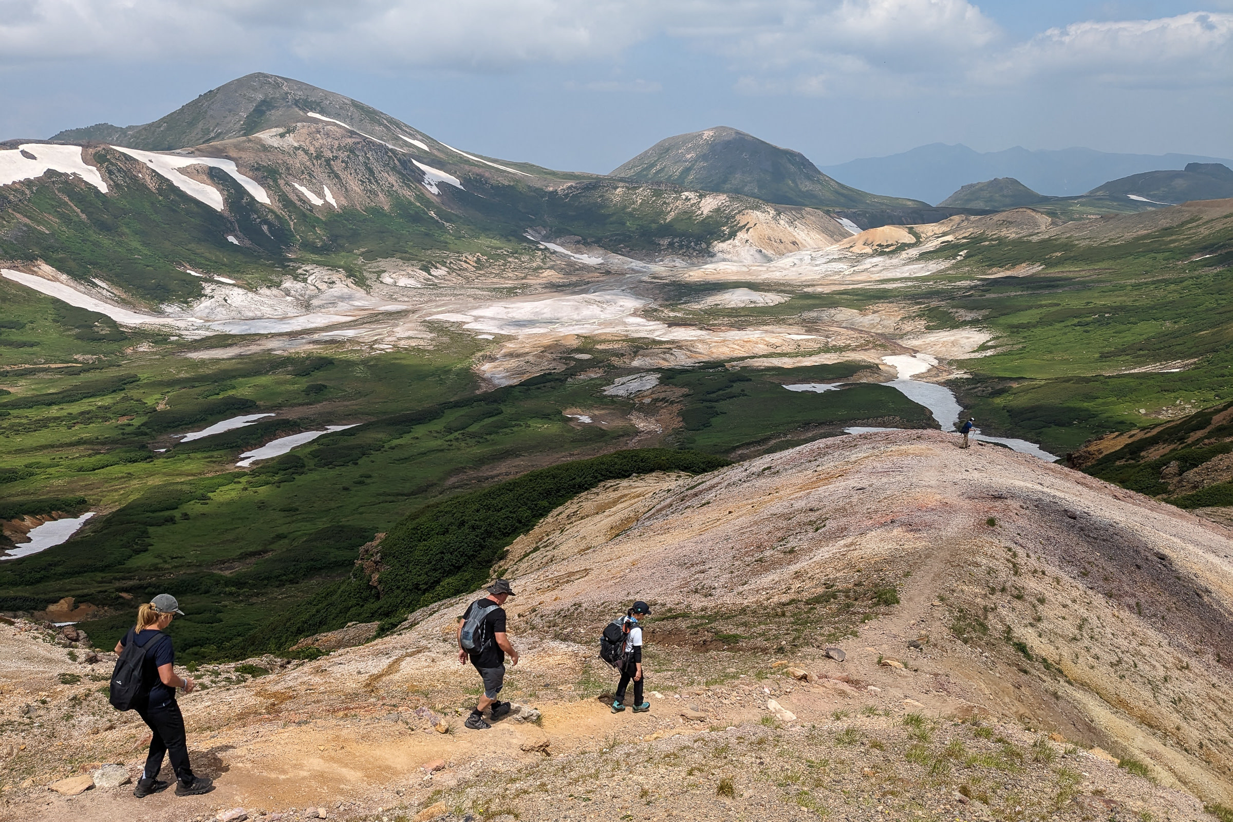 Hikers descend Mt. Asahidake and approach Ohachidaira.
