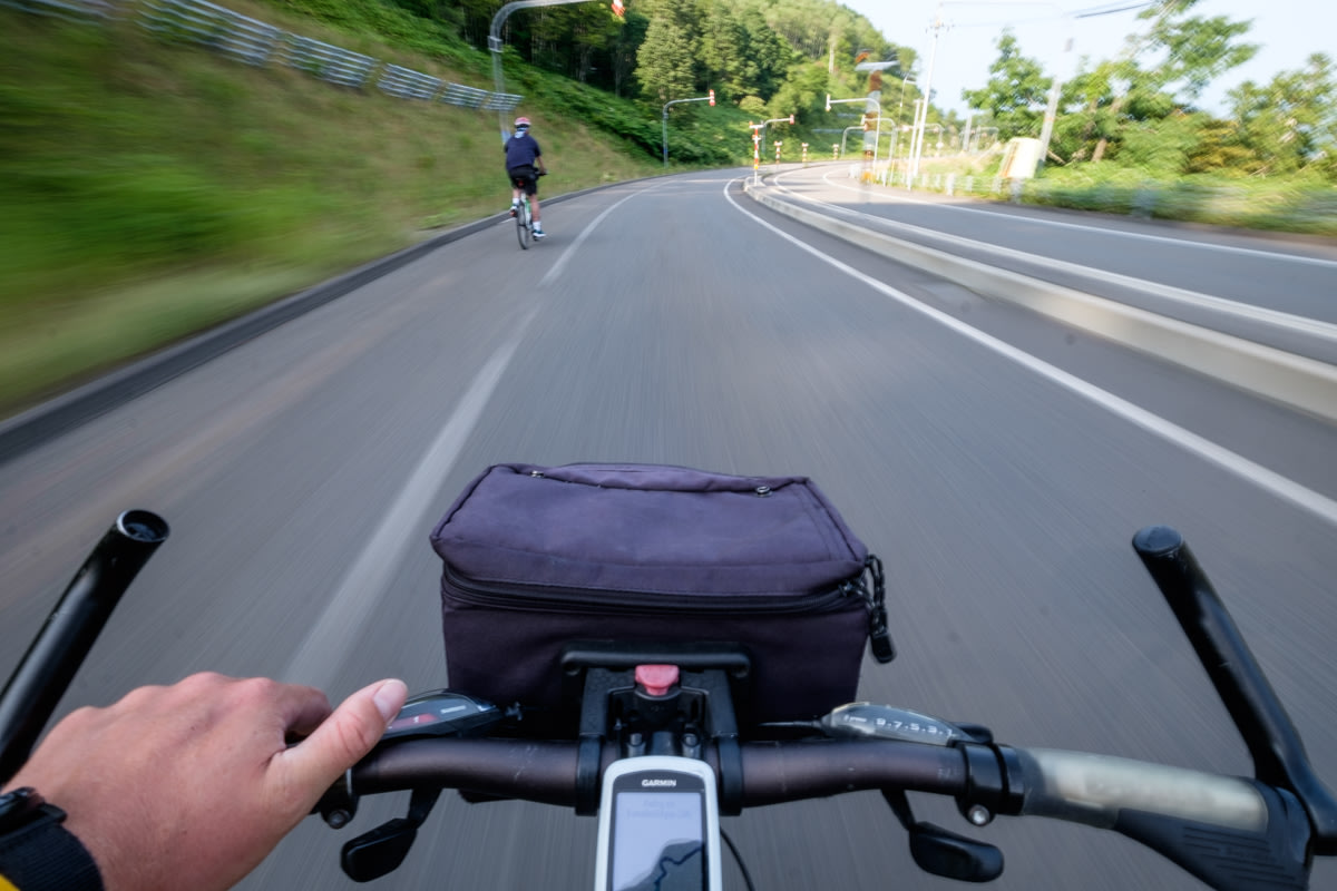 A first person view of a cyclist speeding downhill
