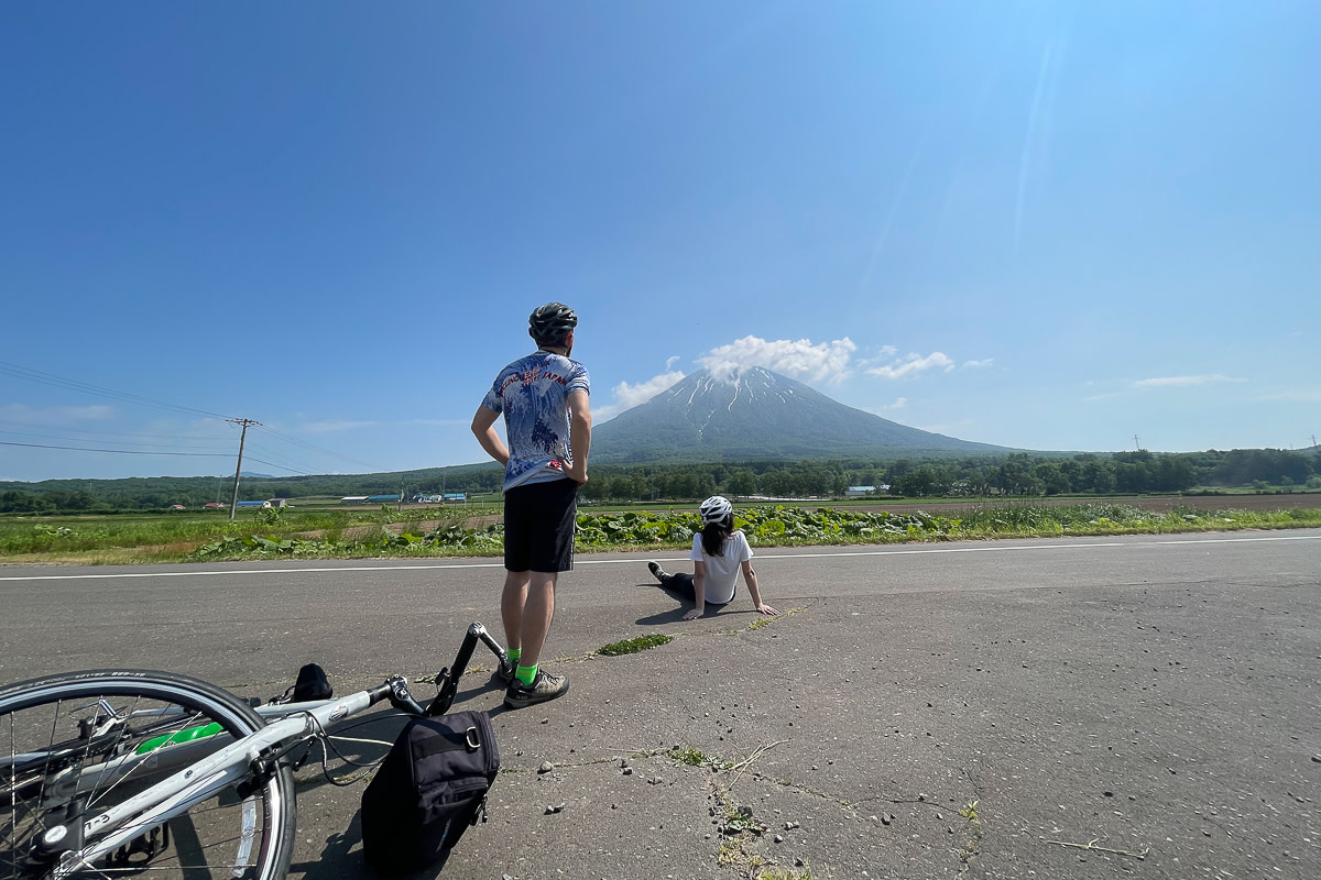 Cyclists take in the view of Mt Yotei