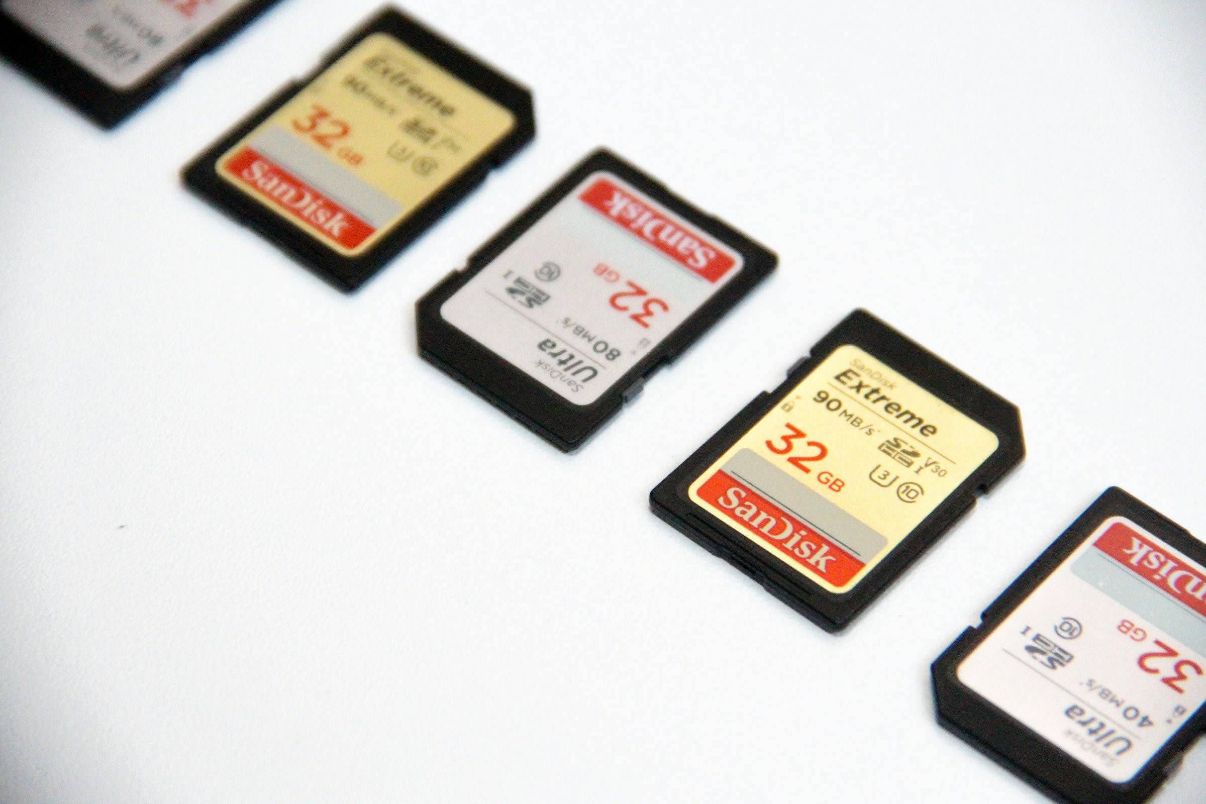 SD storage cards arranged in a line on a white surface.