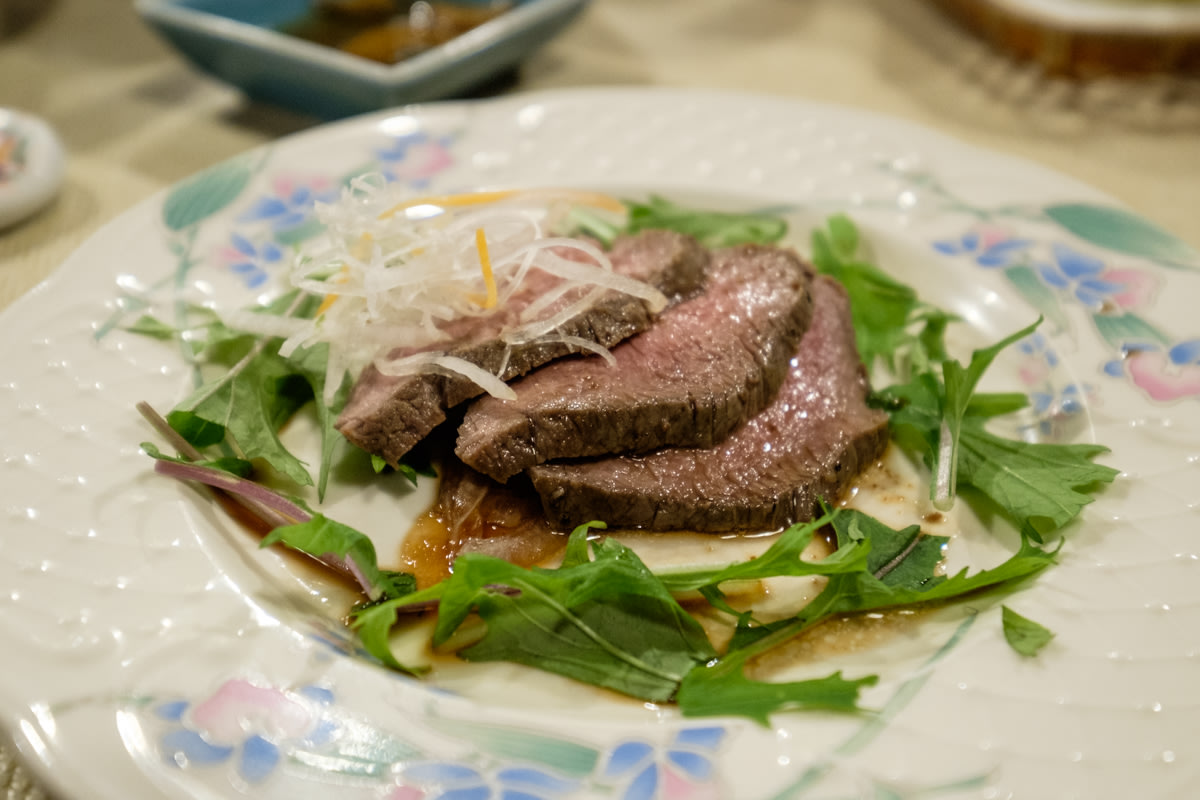 Slices of venison served with green leaves