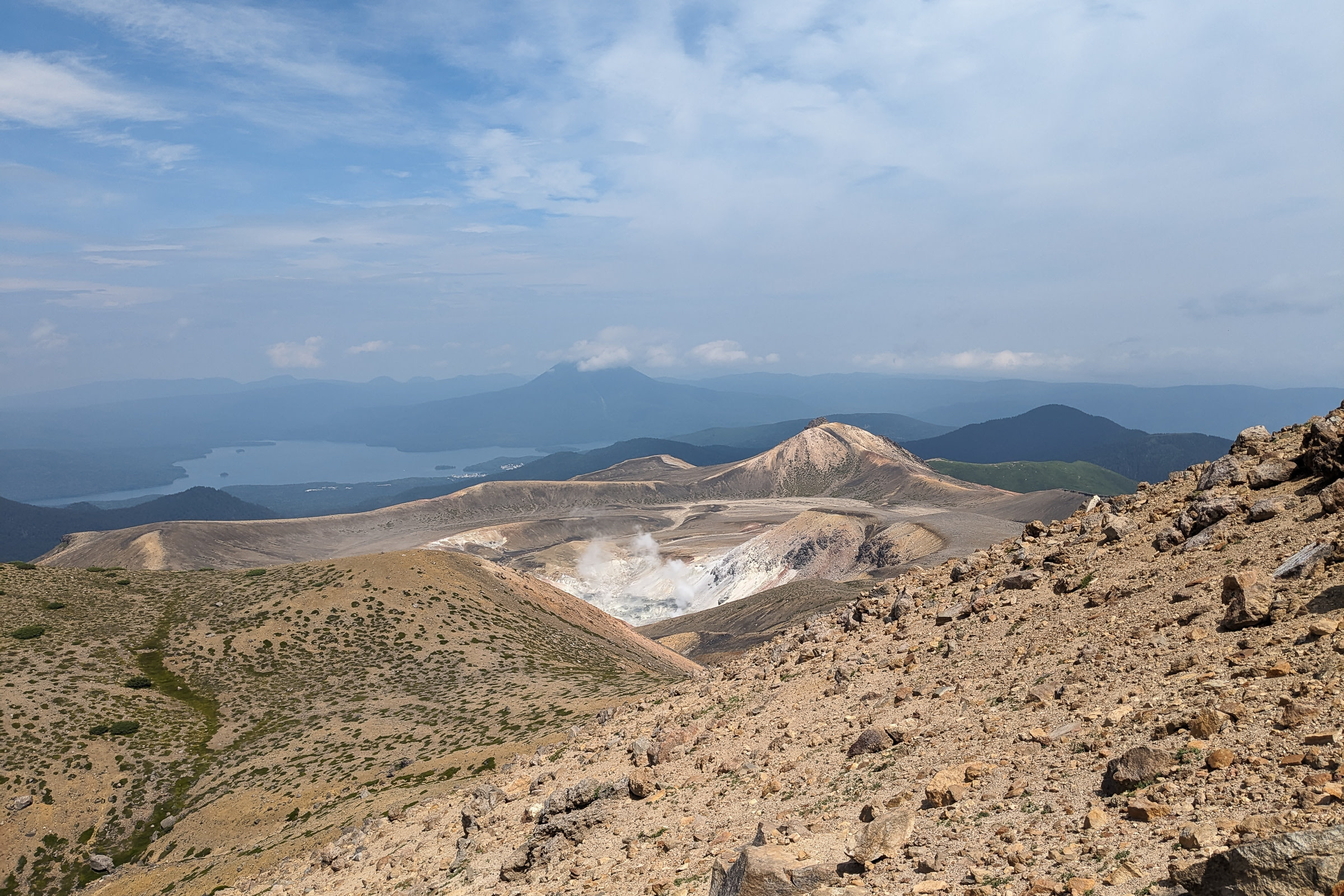 A view of fumaroles with Lake Akan, and Mt. Oakan in the distance.