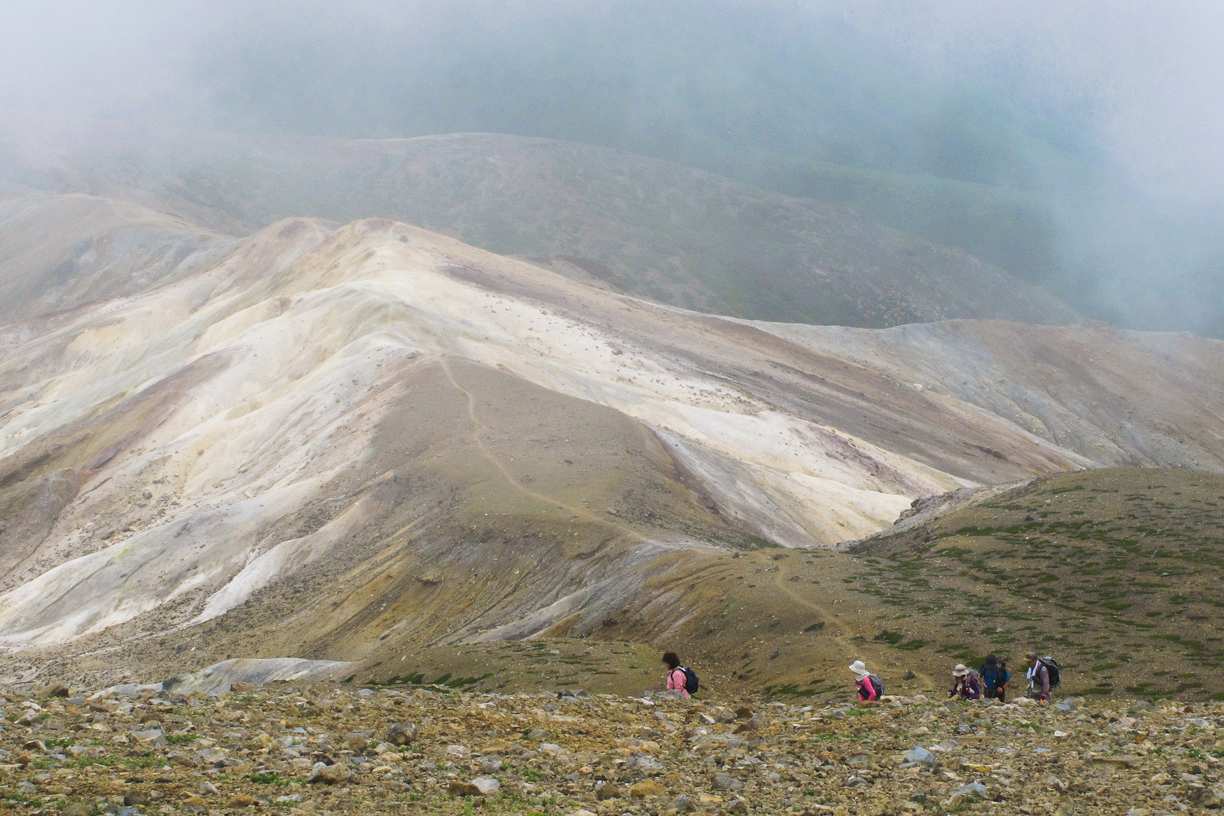 A group of people hiking up Mt. Meakan in the Akan–Mashu National Park