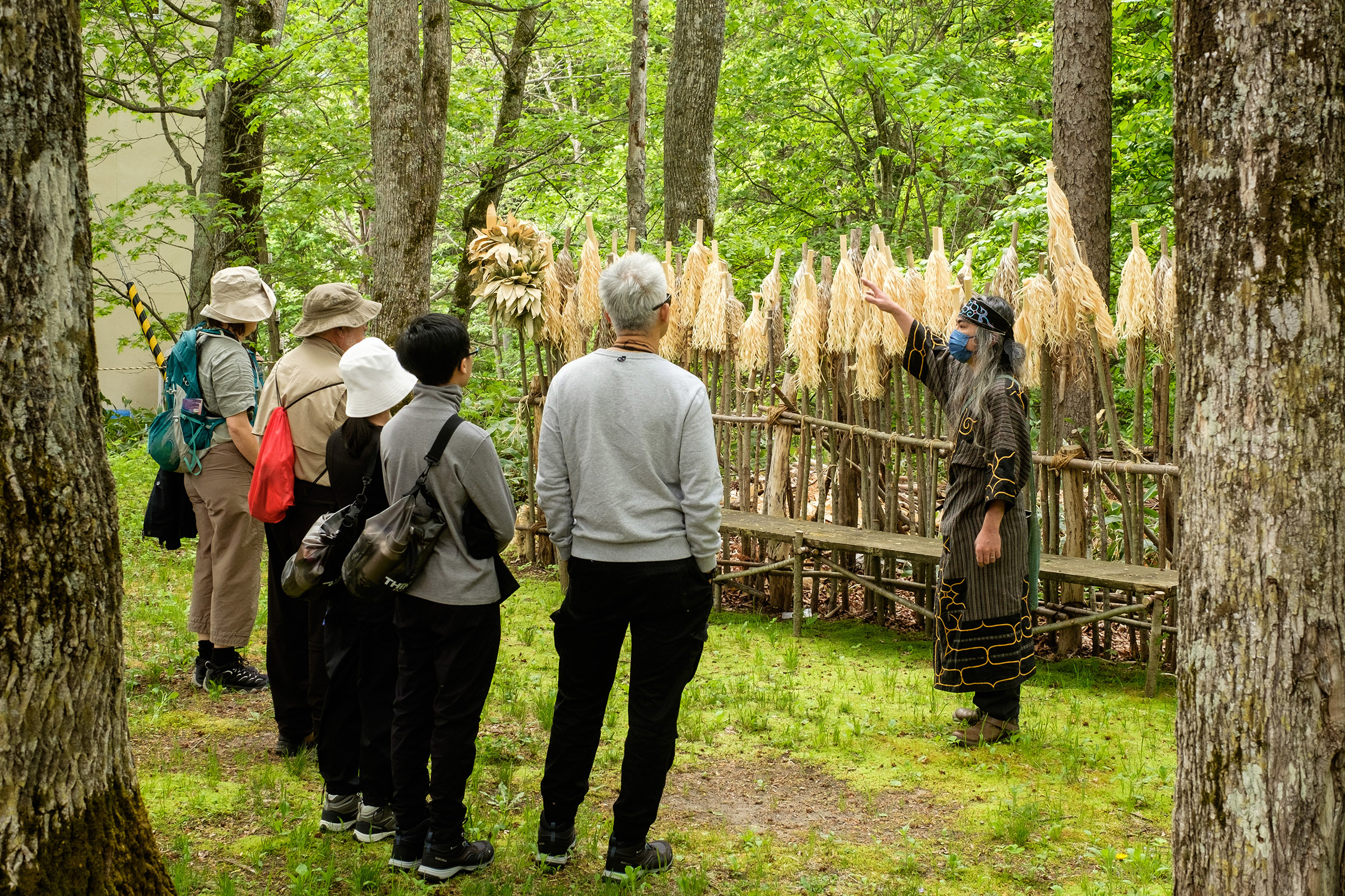 A Ainu guide explains sacred Inau on display at the Lake Akan Ainu Kotan