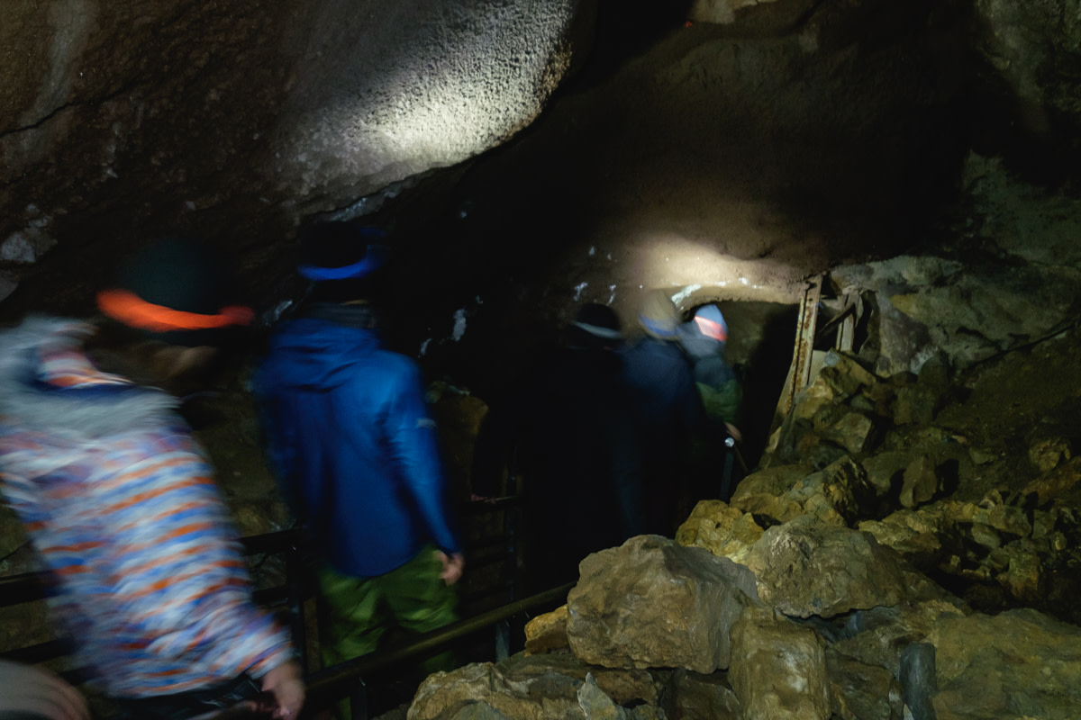 Walking into the darkness of a limestone cave