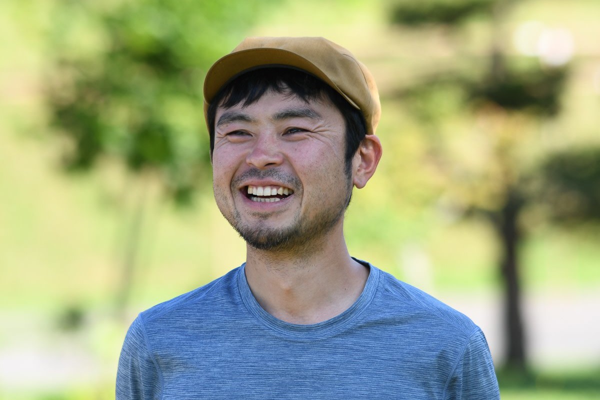Adventure Hokkaido Guide Ayu smiles while wearing a yellow flat cap