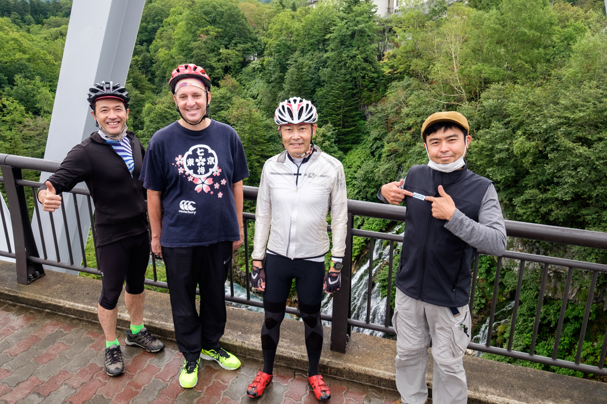 A group of cyclists pose before starting their ride