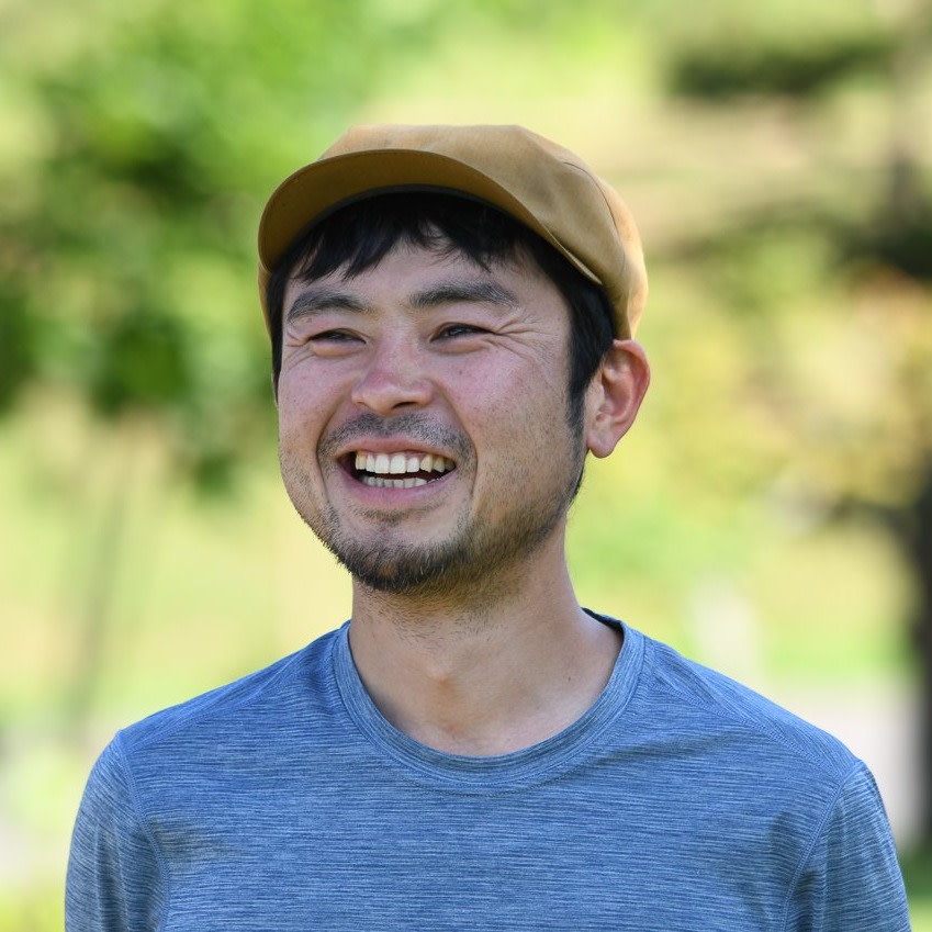 Adventure Hokkaido Guide Ayu smiles while wearing a yellow flat cap