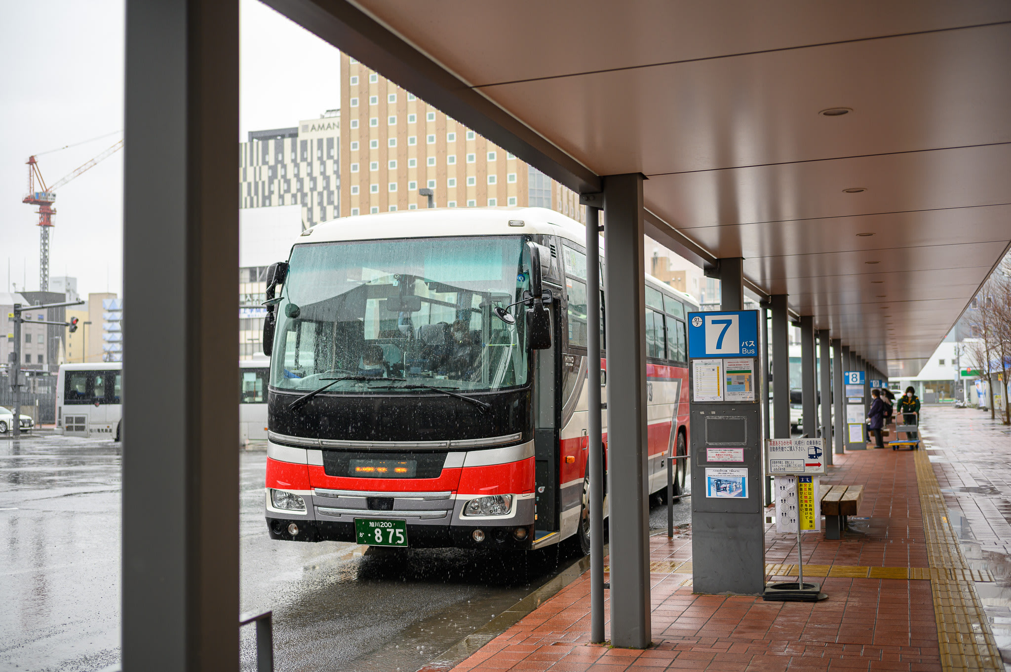A large highway bus bound for Sapporo waits at a bus stop no. 7 at Asahikawa Bus Terminal.
