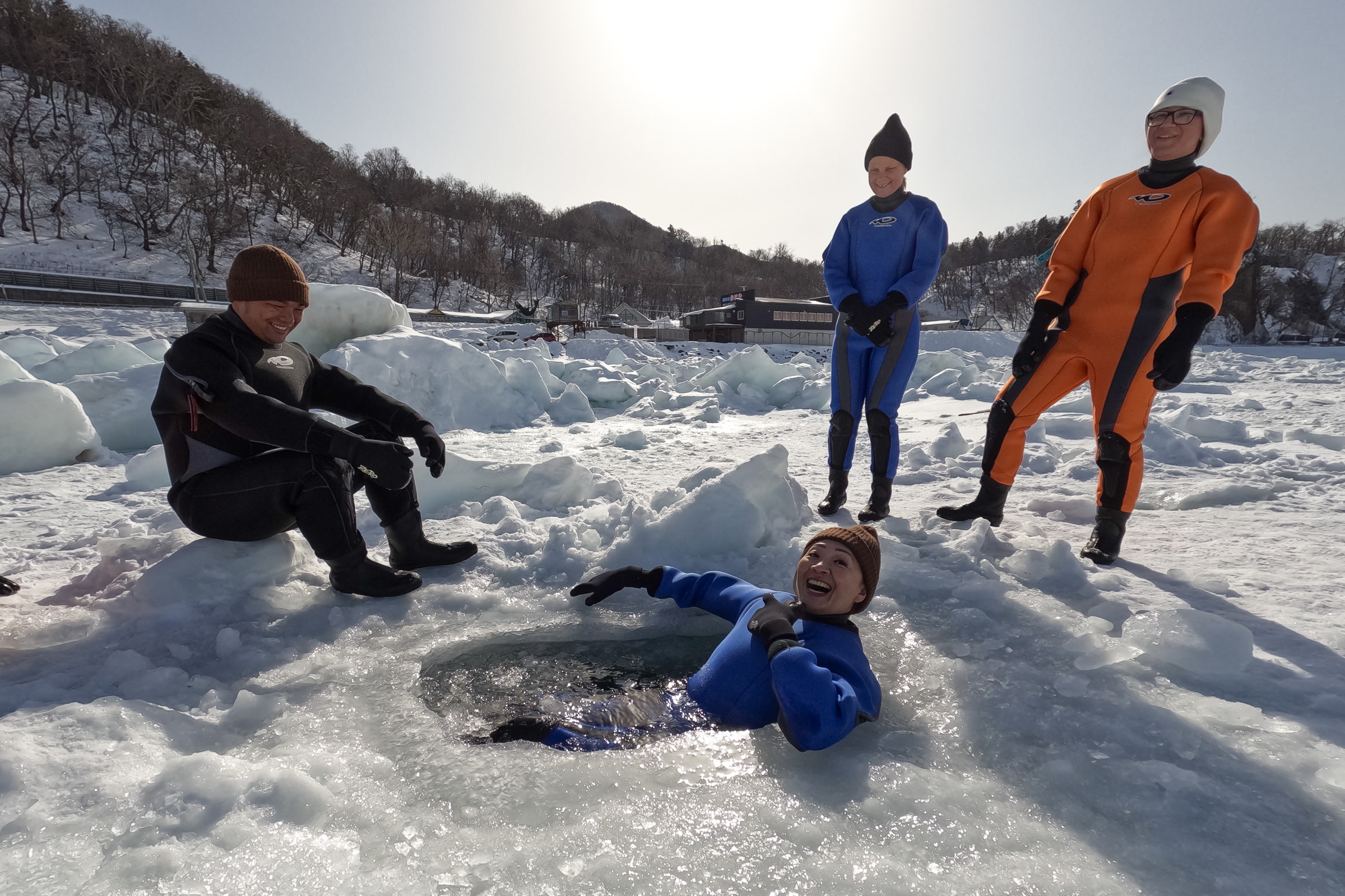 Guests in dry-suits take a winter dip in the frozen Okhotsk Sea.